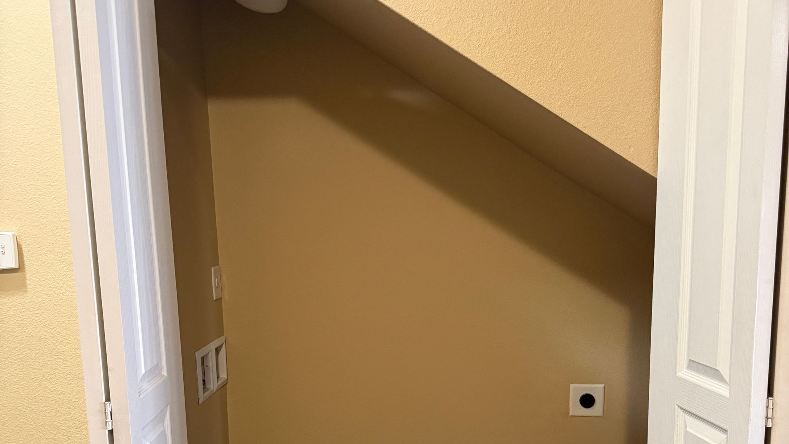 Cozy nook with a sloped ceiling, ideal for creative storage solutions in a charming apartment.