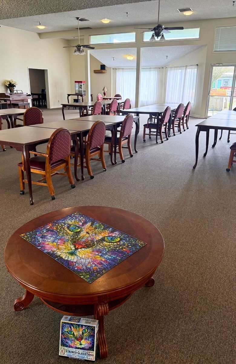 Inviting communal room for hosting resident gatherings, bathed in natural light from large windows.