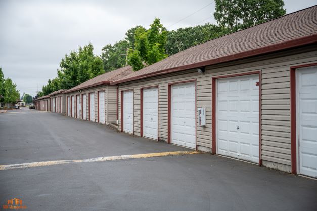 Secure garages with easy access and surrounded by lush greenery, perfect for apartment residents seeking convenient additional storage.