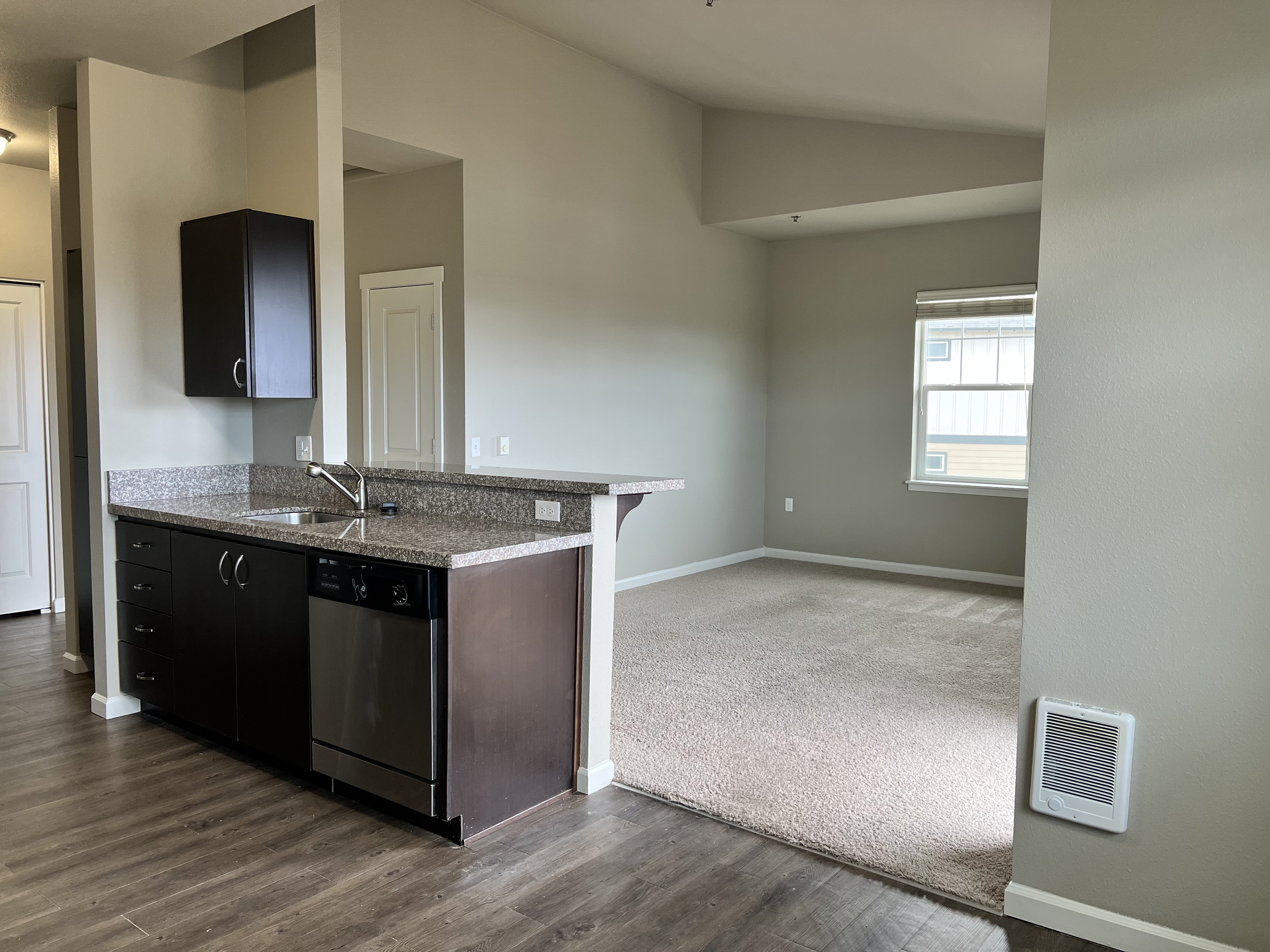 Elegant open-concept kitchen and living area featuring sleek countertops and abundant natural light.