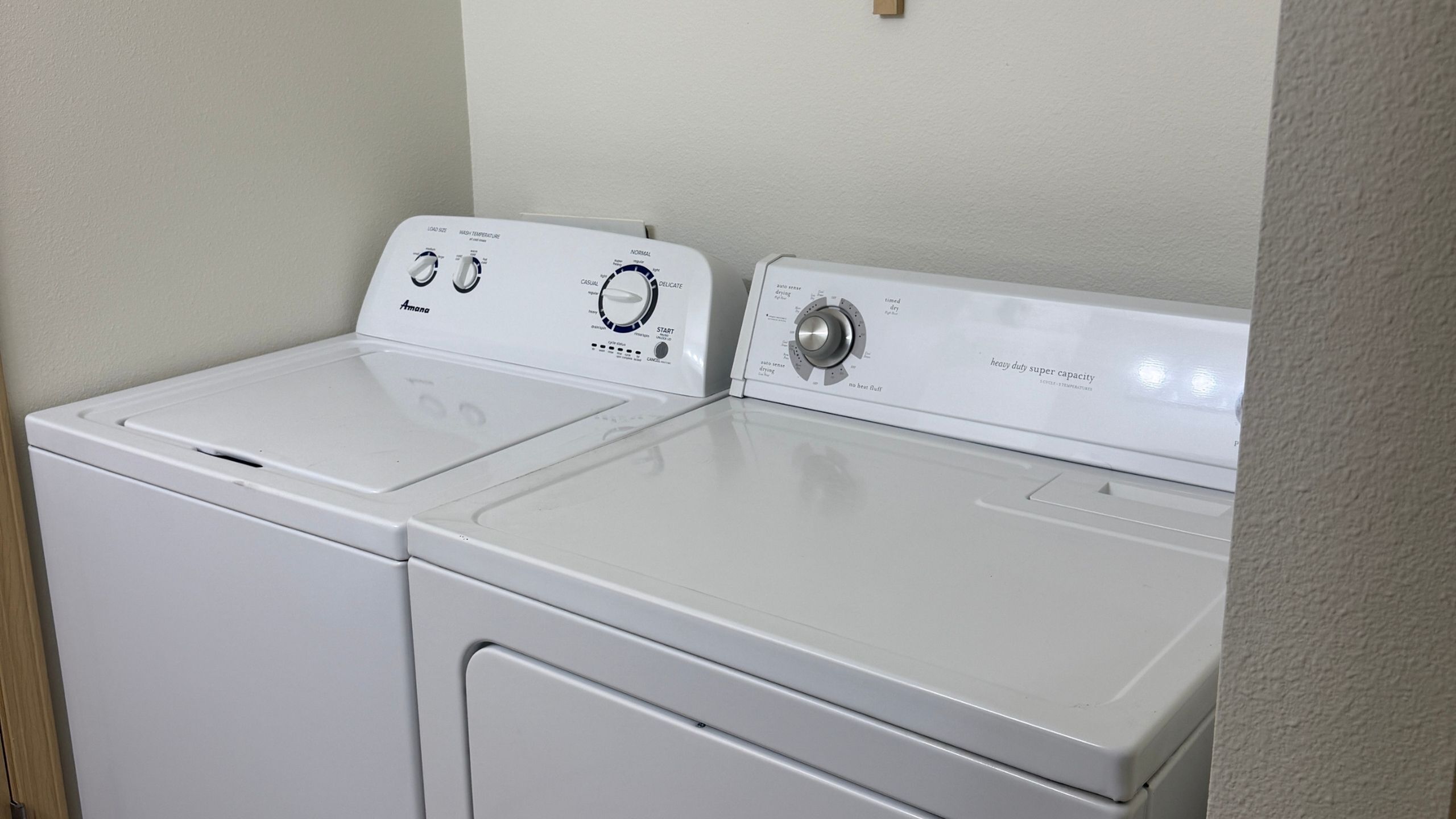 Modern laundry area featuring a white washer and dryer duo for efficient, spacious cleaning.