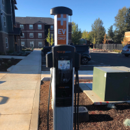 Modern EV charging station in a scenic residential area, enhancing sustainable living in style.