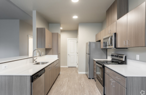 Modern kitchen with sleek cabinetry, stainless steel appliances, and elegant countertops, offering a contemporary and functional cooking space.