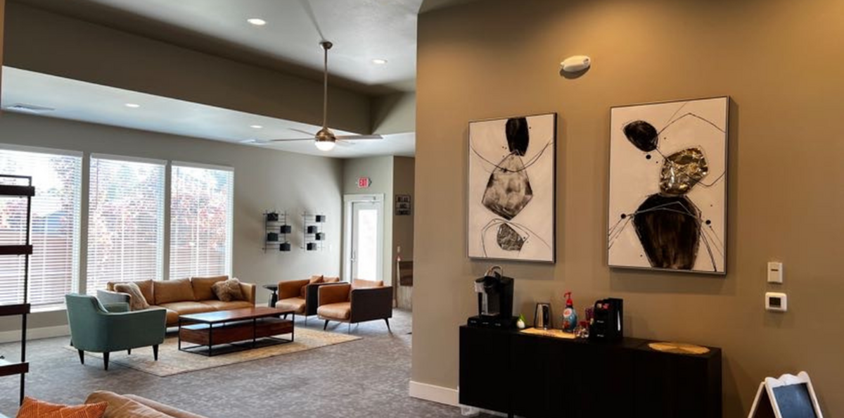 Modern and inviting living space with stylish decor, large windows, and comfortable seating perfect for relaxation and socializing.