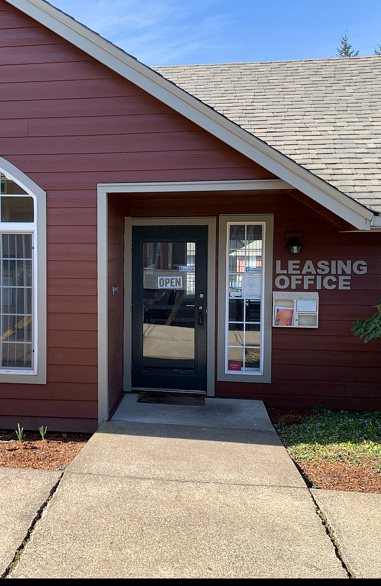 Inviting leasing office with charming arched windows and welcoming entrance, perfect for starting your new apartment journey.