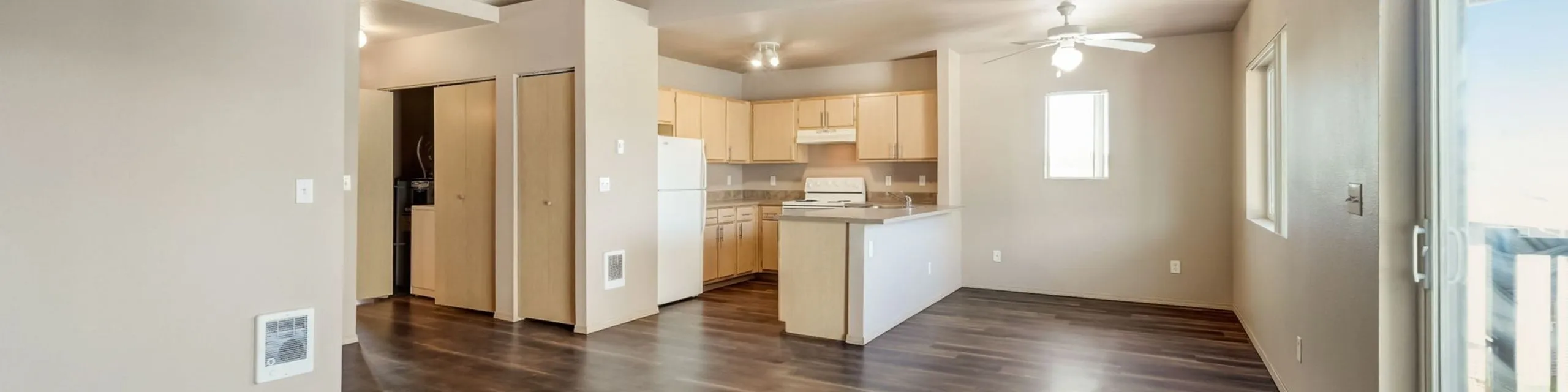 Bright open-concept kitchen and living area with modern flooring and ample natural light.