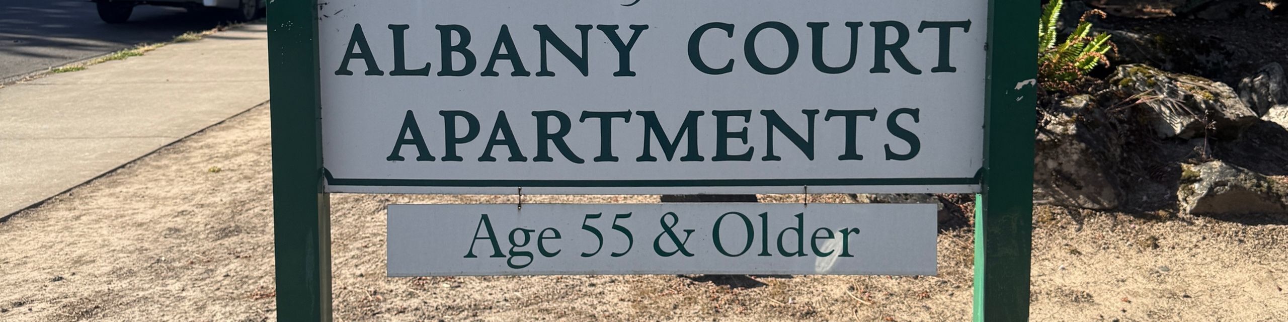 Inviting Albany Court Apartments sign highlighting living options for the 55 and older community.