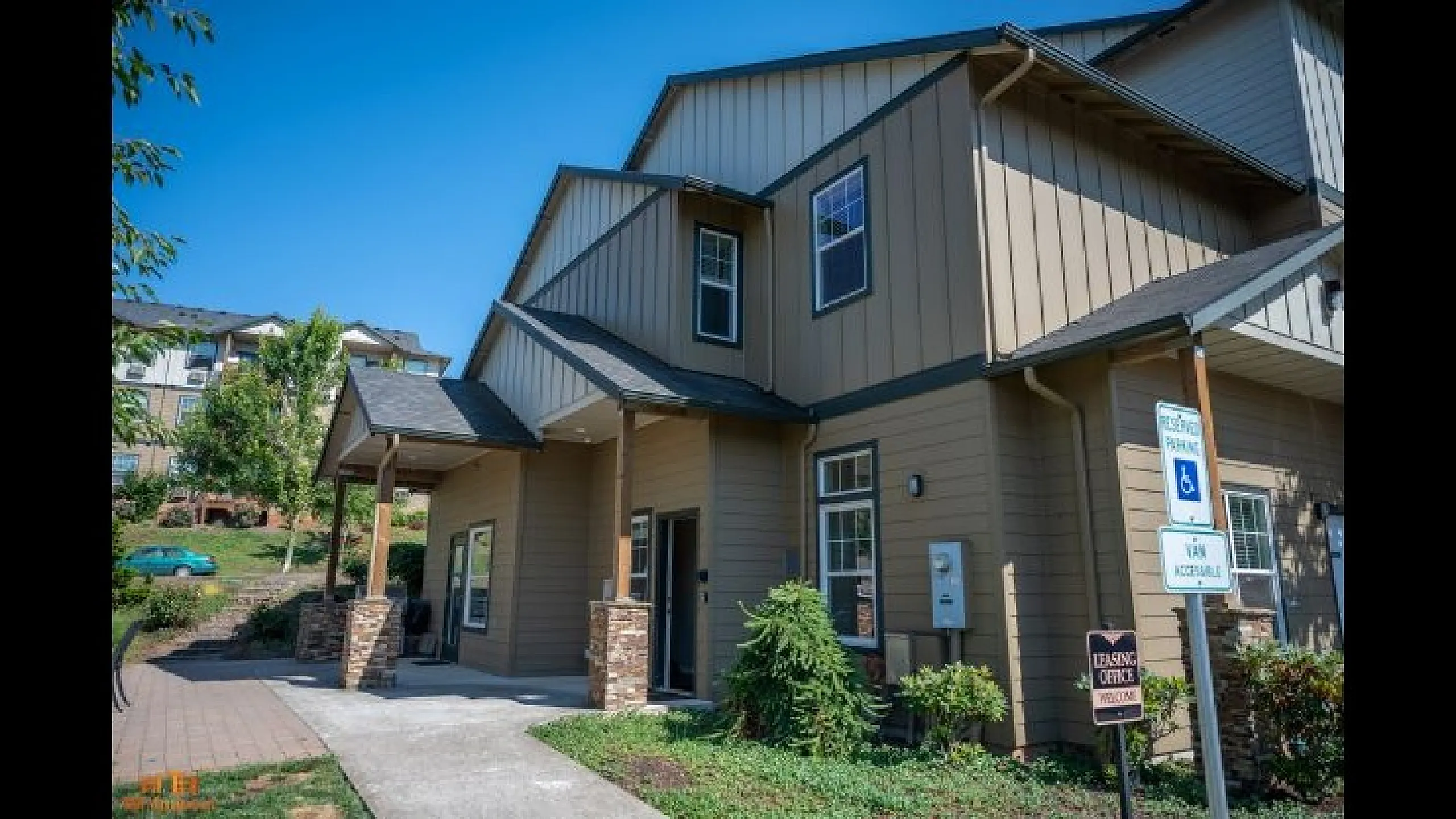 Charming townhouse with modern design, featuring a welcoming front entrance and lush landscaping for serene living.