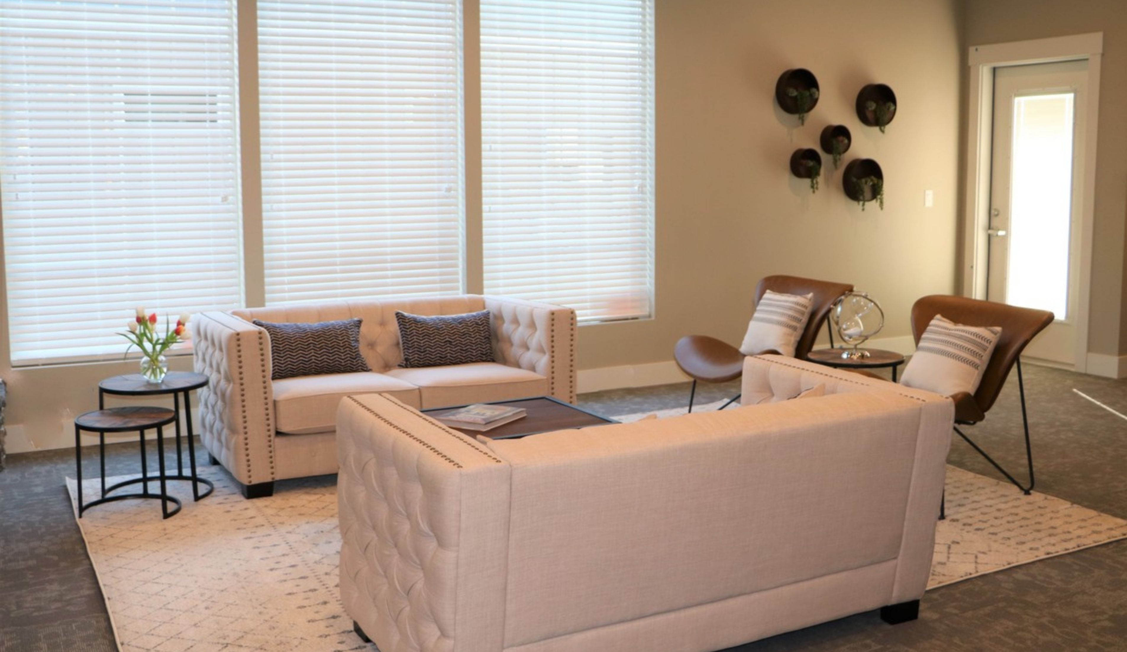 Inviting living room with plush seating, modern decor, and large windows offering abundant natural light.