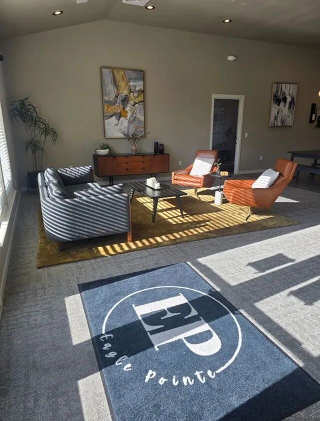 Modern living room with stylish furniture, abstract art, and abundant natural light at Eagle Pointe.