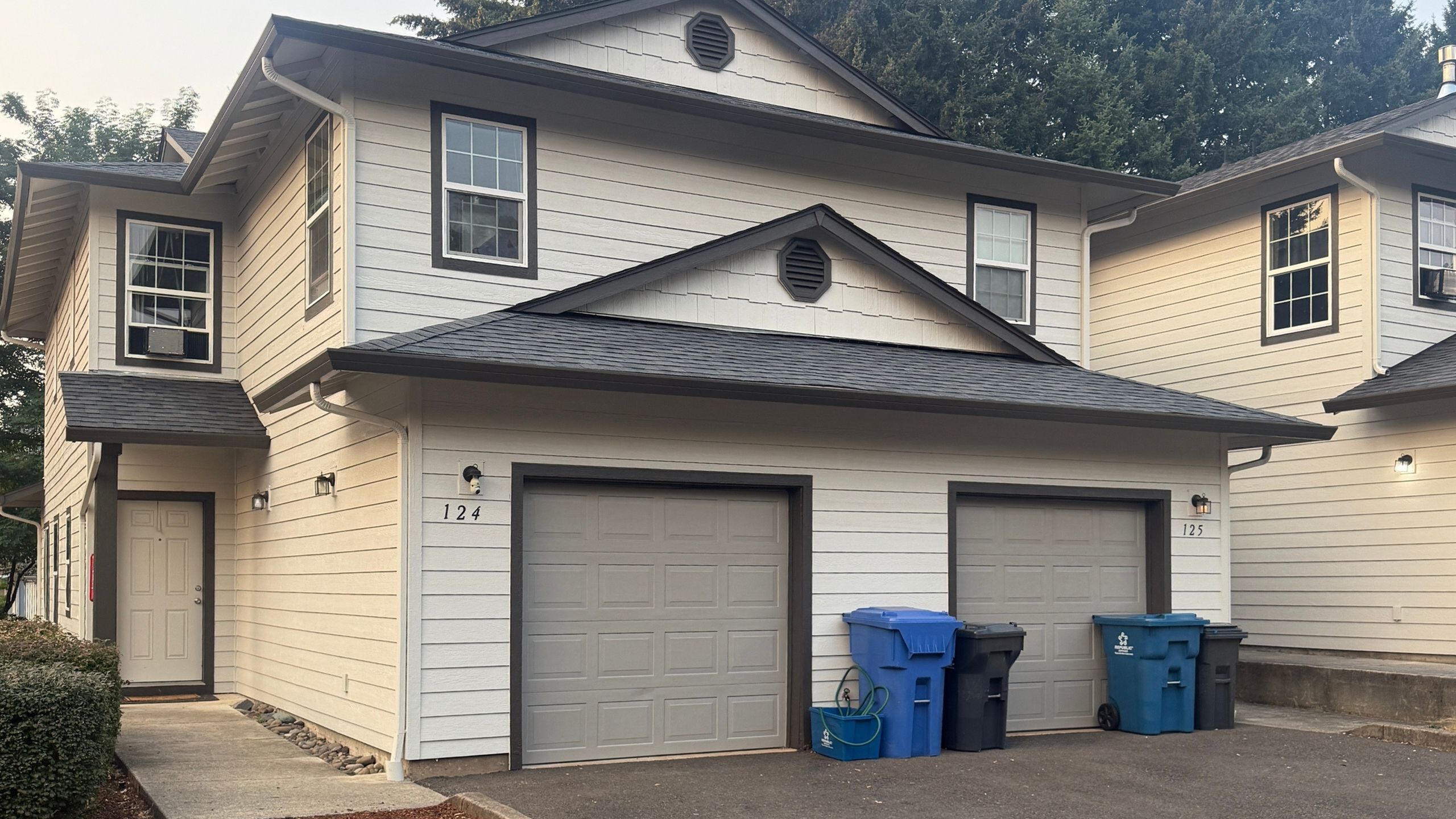 Charming two-story townhouse with double garages and elegant exterior design.
