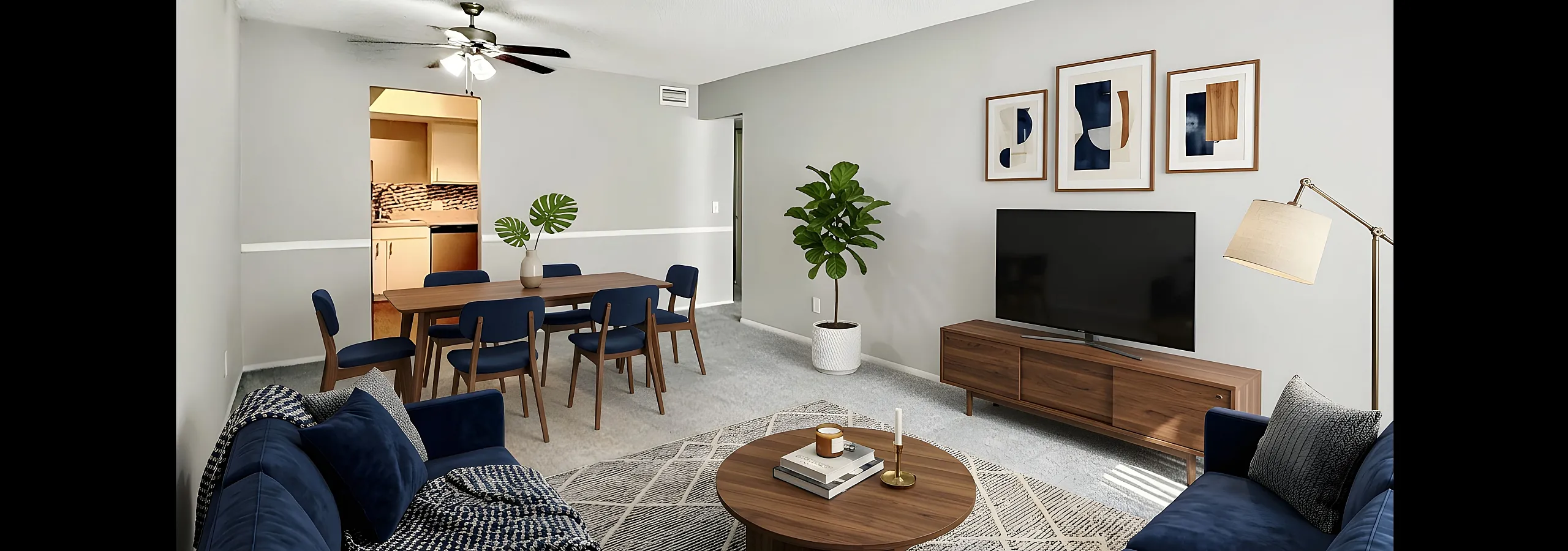 Contemporary living and dining area with stylish navy furniture, sleek wood accents, and elegant decor.