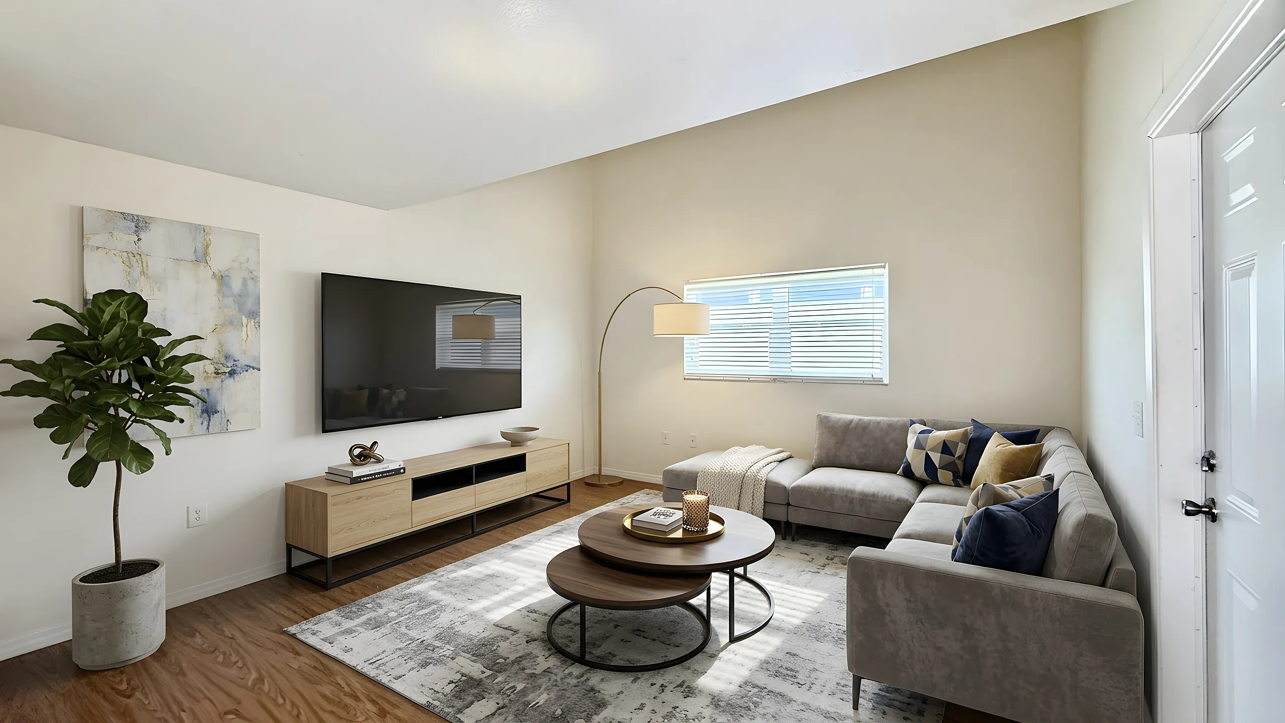 Modern living room with sleek furnishings, featuring a large flat-screen TV, cozy sectional sofa, stylish coffee tables, and elegant decor for a contemporary feel.