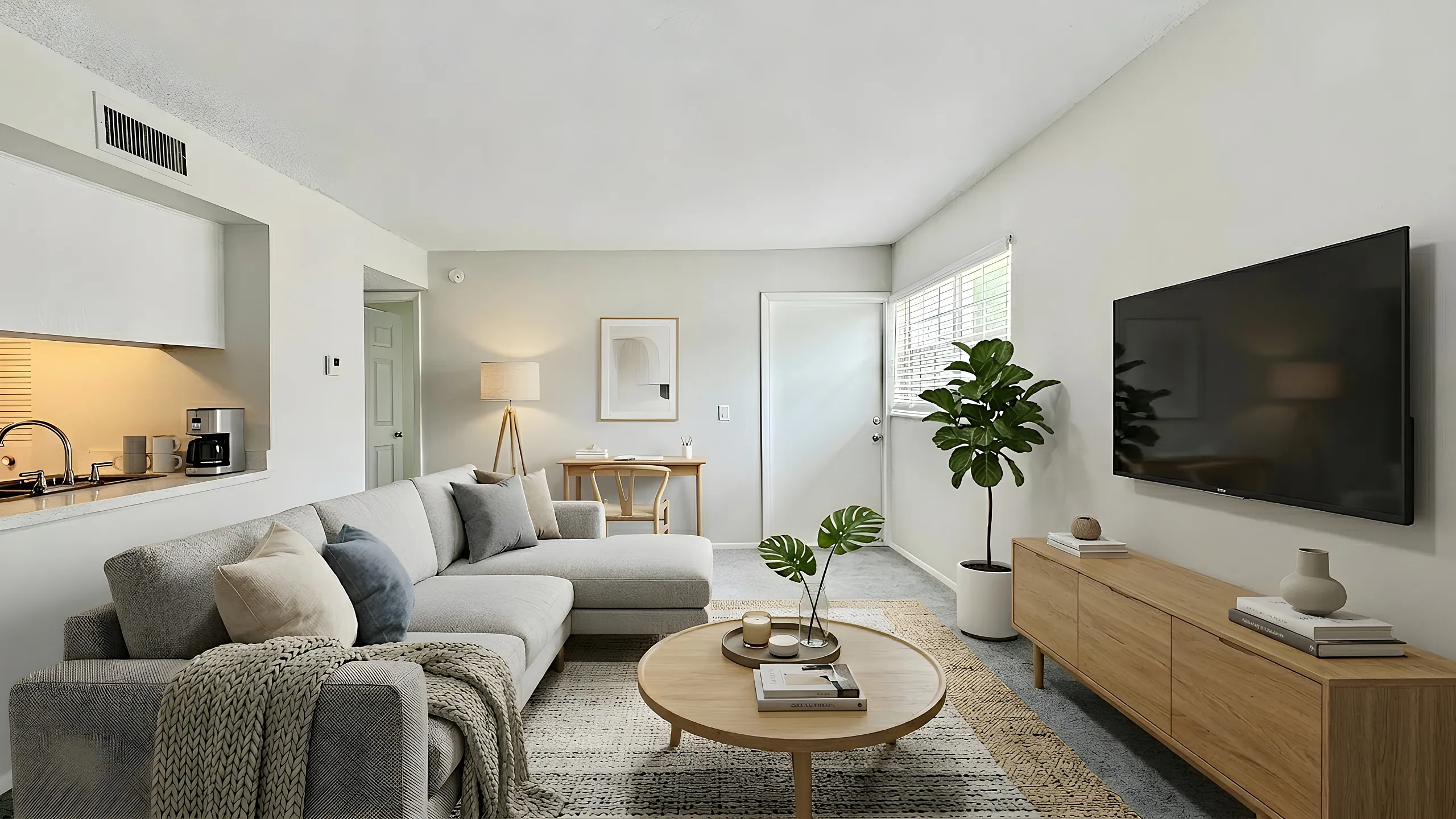 Bright and inviting living room with a modern sofa, stylish decor, a flat-screen TV, and plenty of natural light. Perfect for relaxation and entertaining.