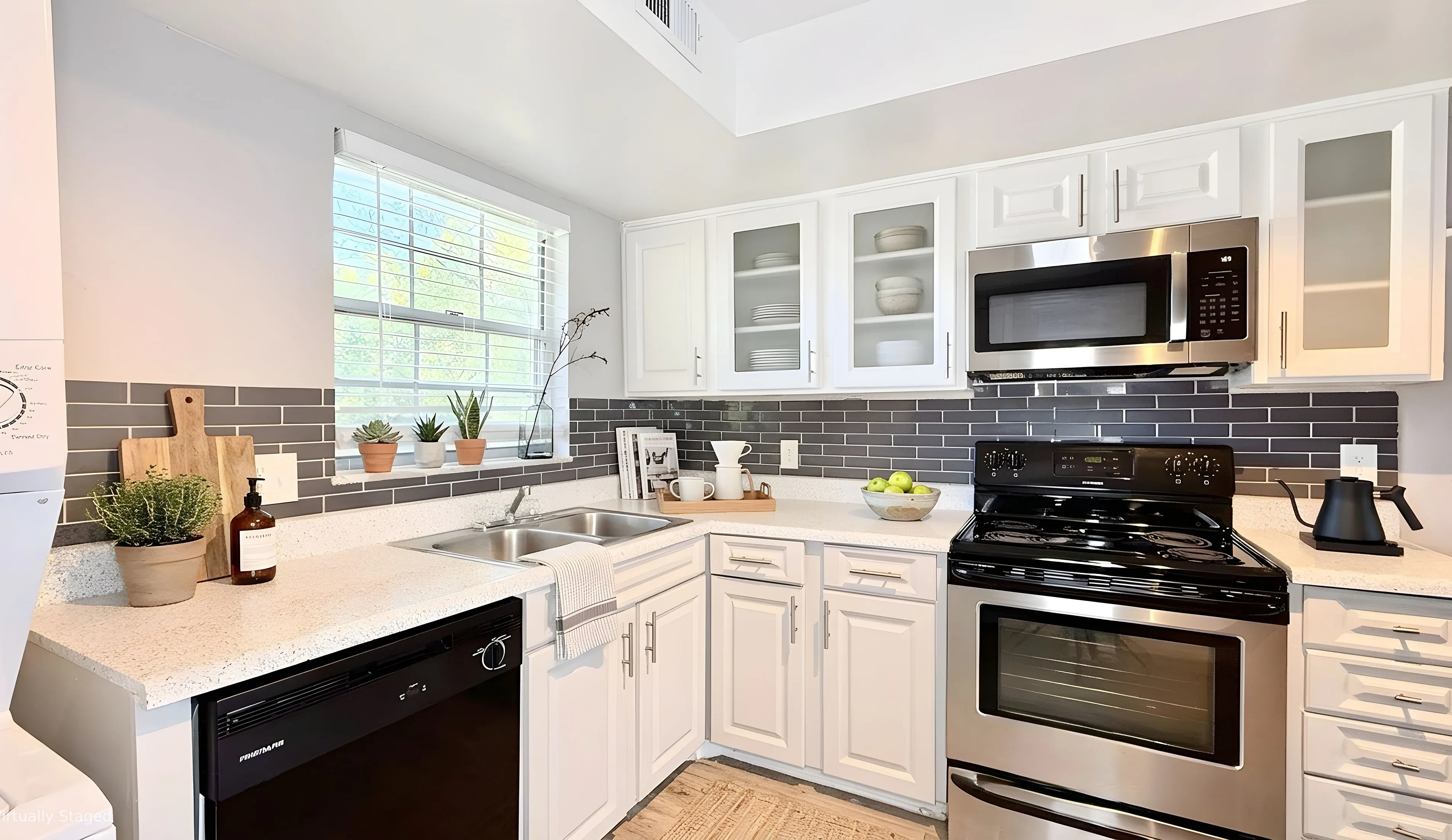 Charming modern kitchen with sleek stainless steel appliances, elegant white cabinetry, and chic subway tile backsplash, complemented by natural light and stylish decor.