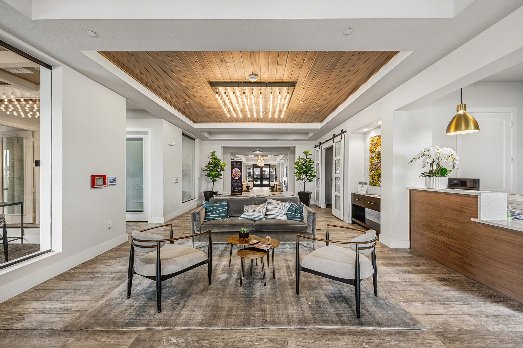 Luxurious lobby with modern seating, elegant lighting, and contemporary decor in a welcoming apartment building.