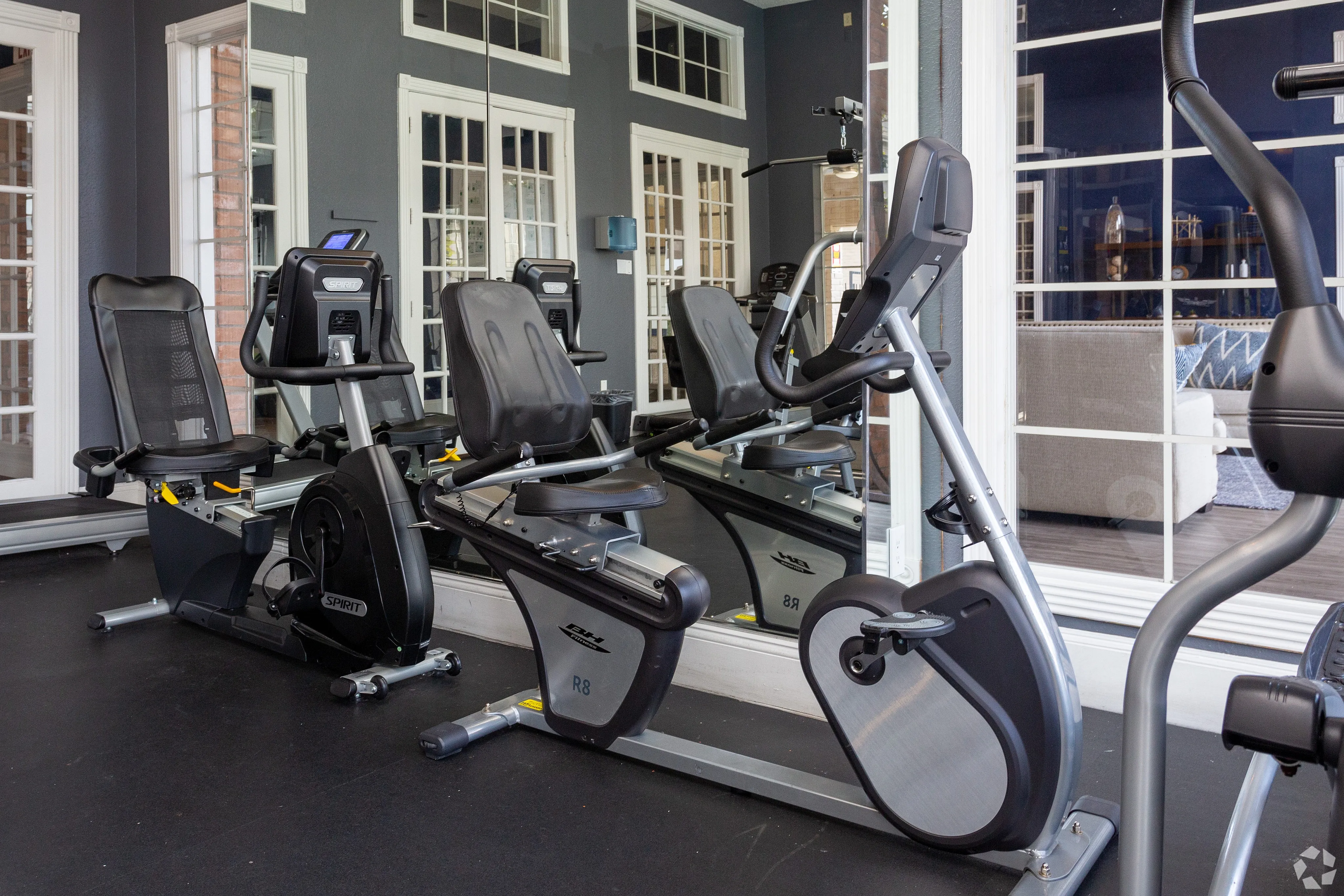 Modern fitness center with state-of-the-art exercise bikes, large mirrors, and stylish interior, perfect for an active lifestyle.