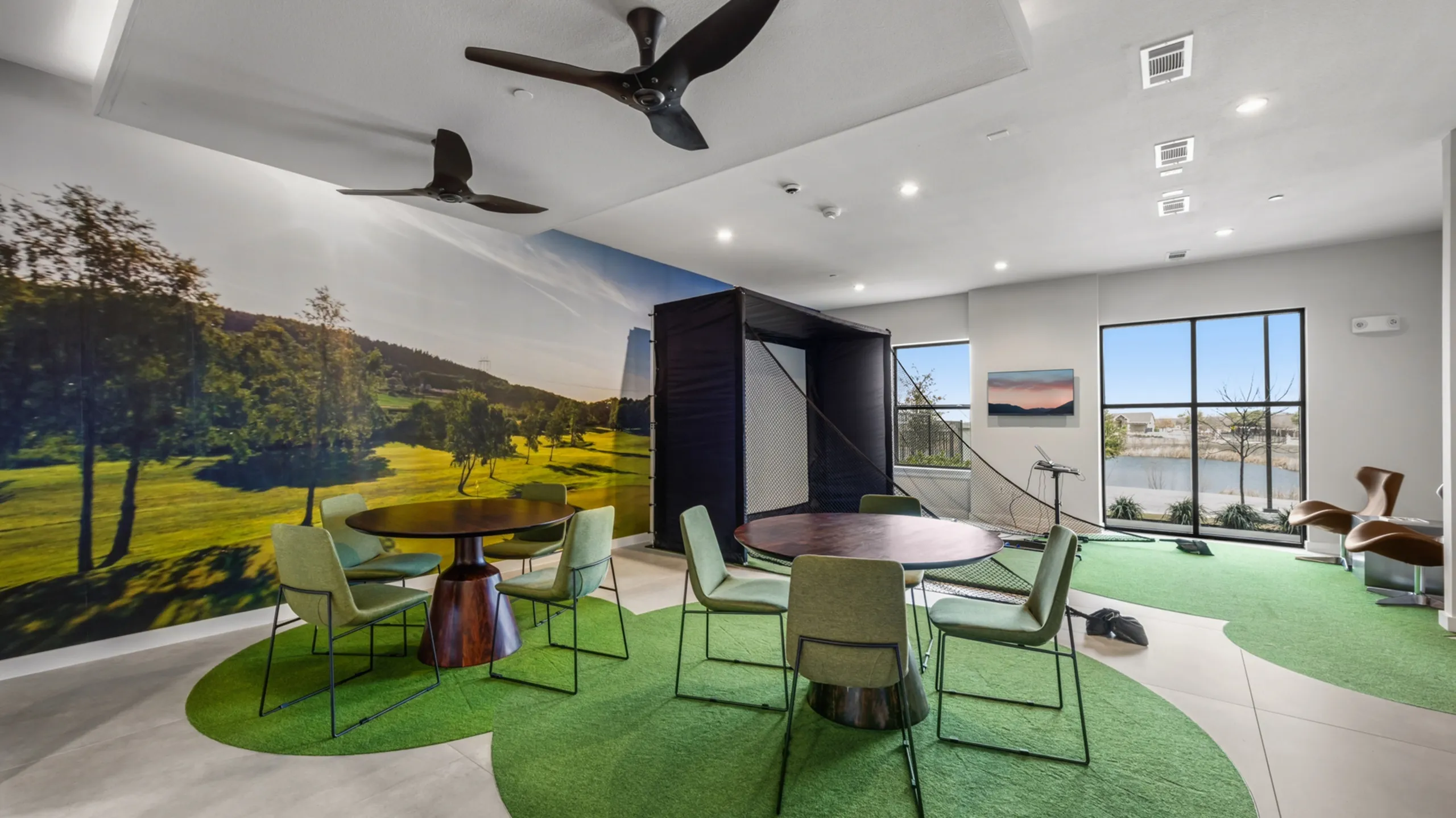 Elegant apartment lounge featuring modern furniture, vibrant golf-inspired decor, and panoramic window views.