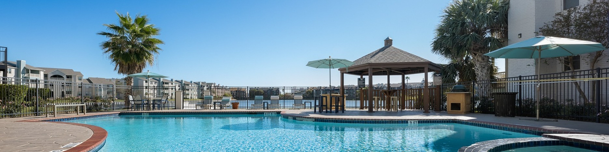 Lakeside at campeche main pool and outdoor kitchen with fireplace grills picninc tables and sun loungers