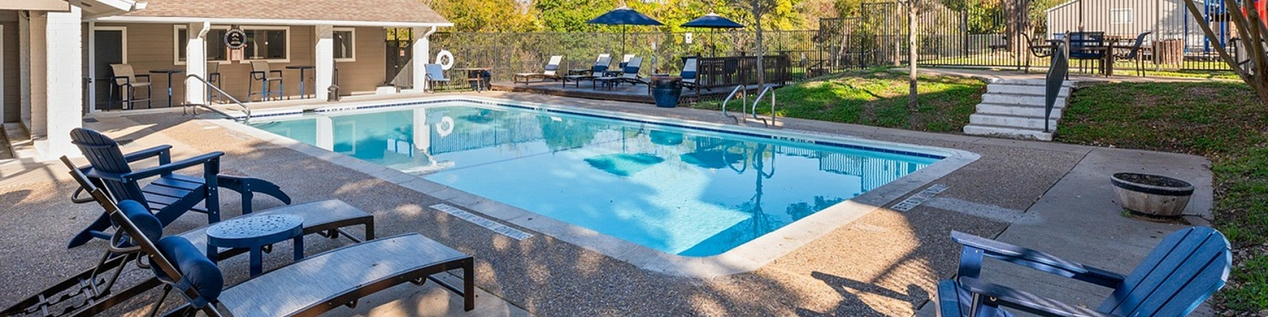Hilltop apartments pool area with ample loungers and picnic areas