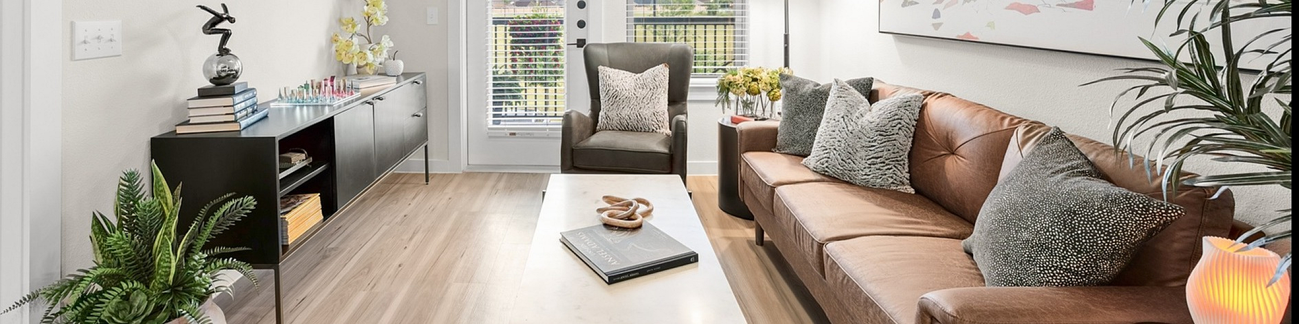 Inviting apartment complex with modern architecture and beautifully landscaped entrance at The Hamilton.