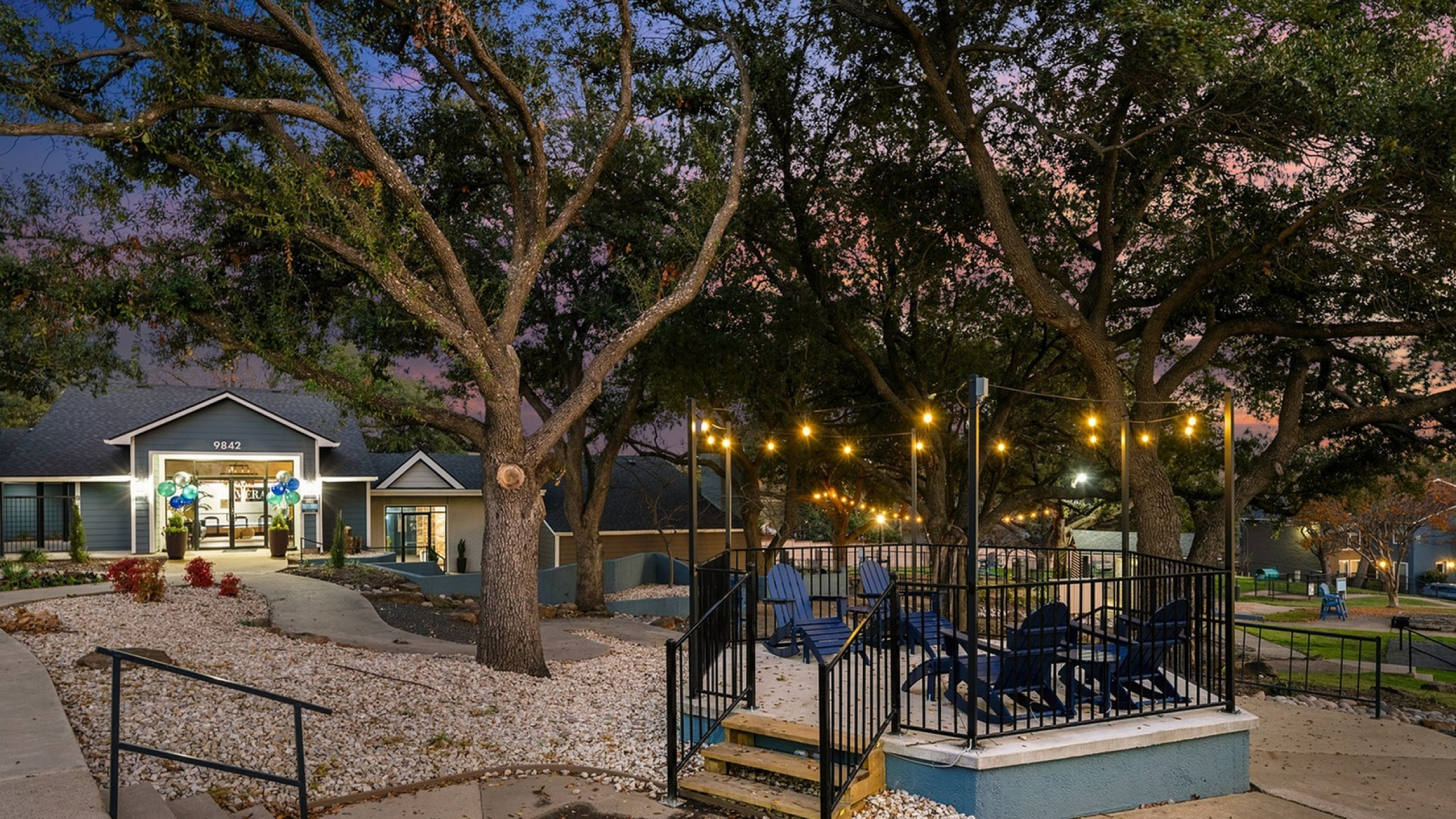 Lavera Apartments Exterior night shot of clubhouse and outdoor cafe seating and community gathering areas