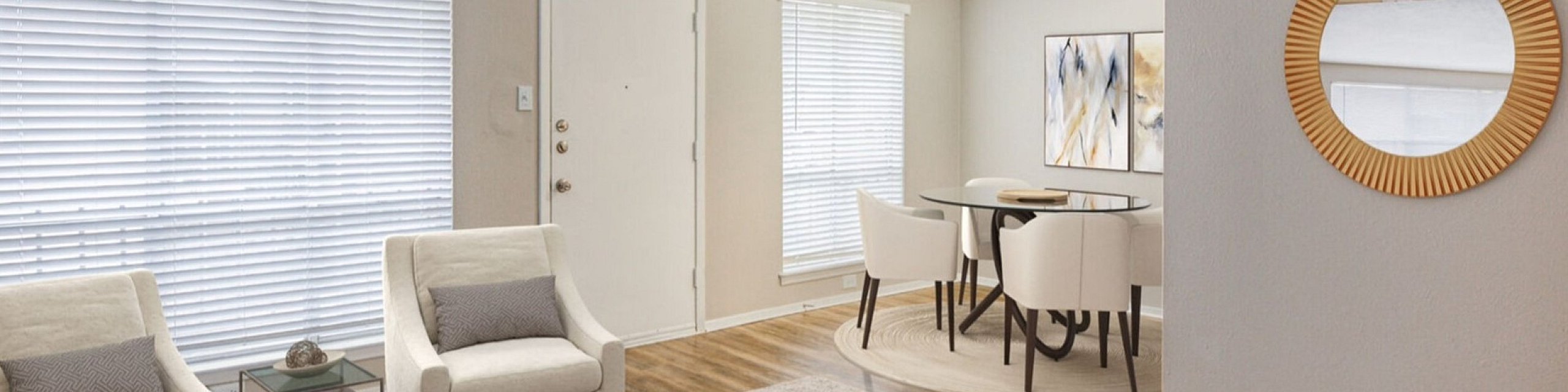 Bright and inviting living room with modern furniture and natural light, adjacent to a stylish dining area with chic decor.