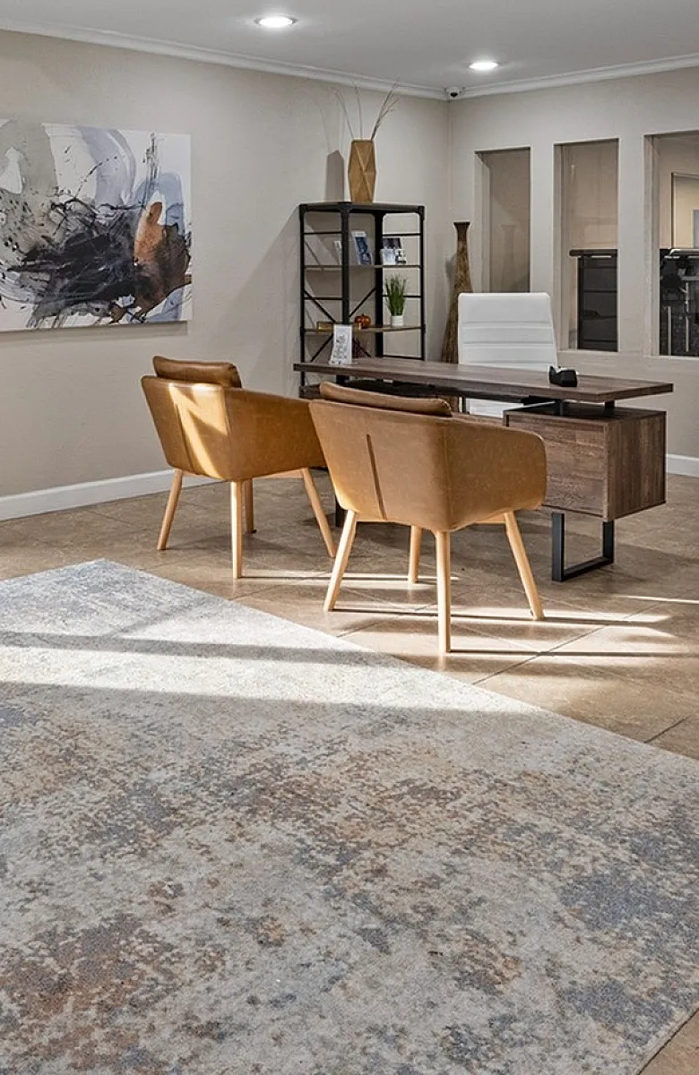 Modern apartment lobby featuring sleek furnishings, natural light, and inviting seating area.