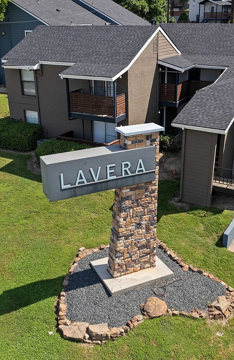 Charming Lavera apartment complex with modern exterior and lush green surroundings, offering a welcoming community vibe.