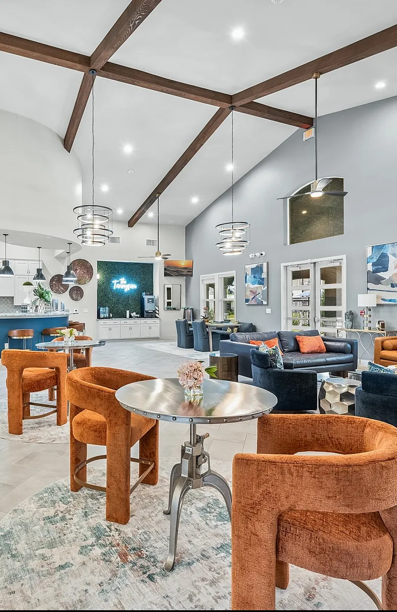 Elegant community lounge featuring stylish modern decor, plush seating areas, and a sleek open-concept kitchen.