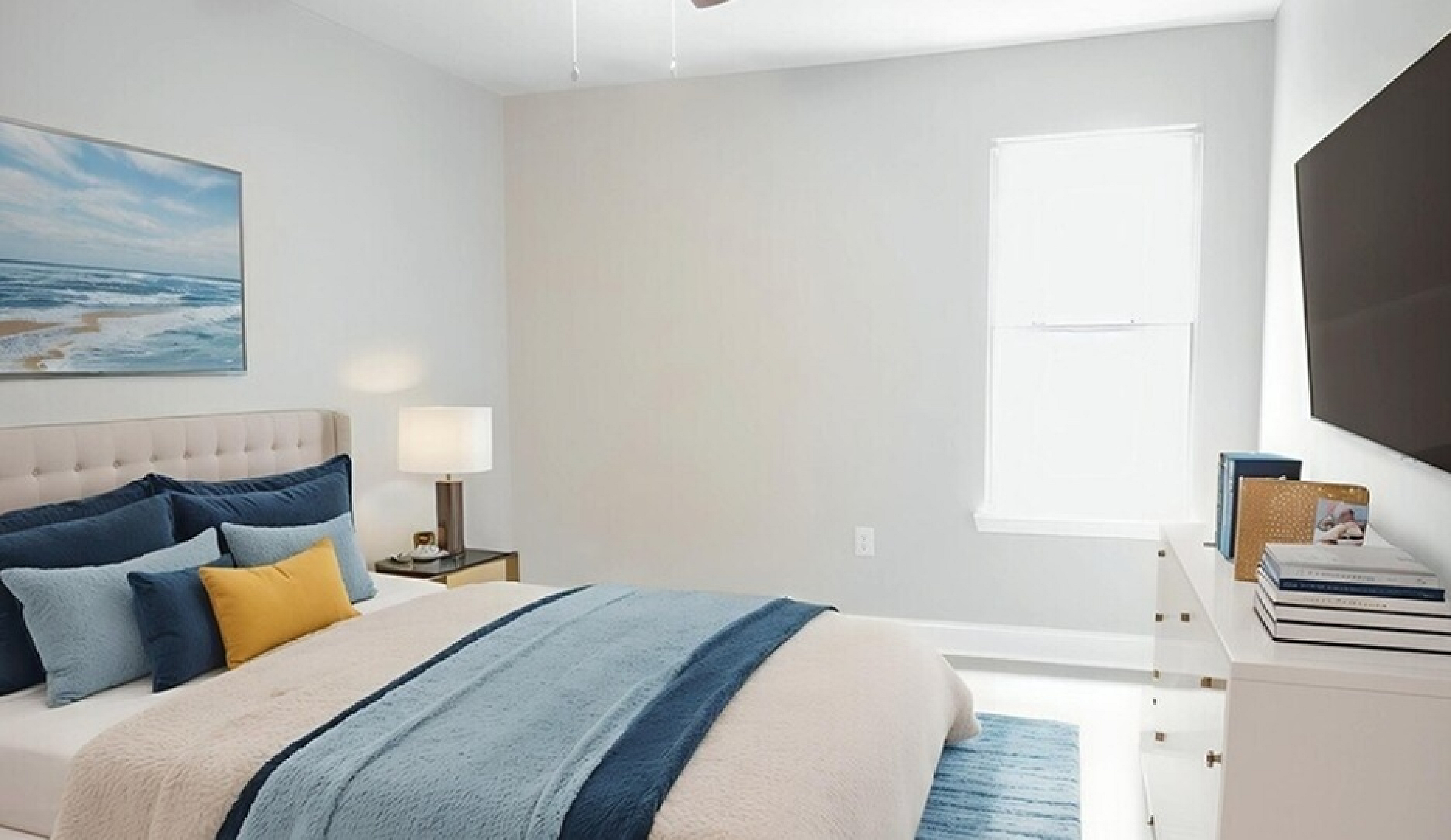 Inviting bedroom with a plush bed, chic blue accents, and a large wall-mounted TV, creating a serene and modern ambiance.
