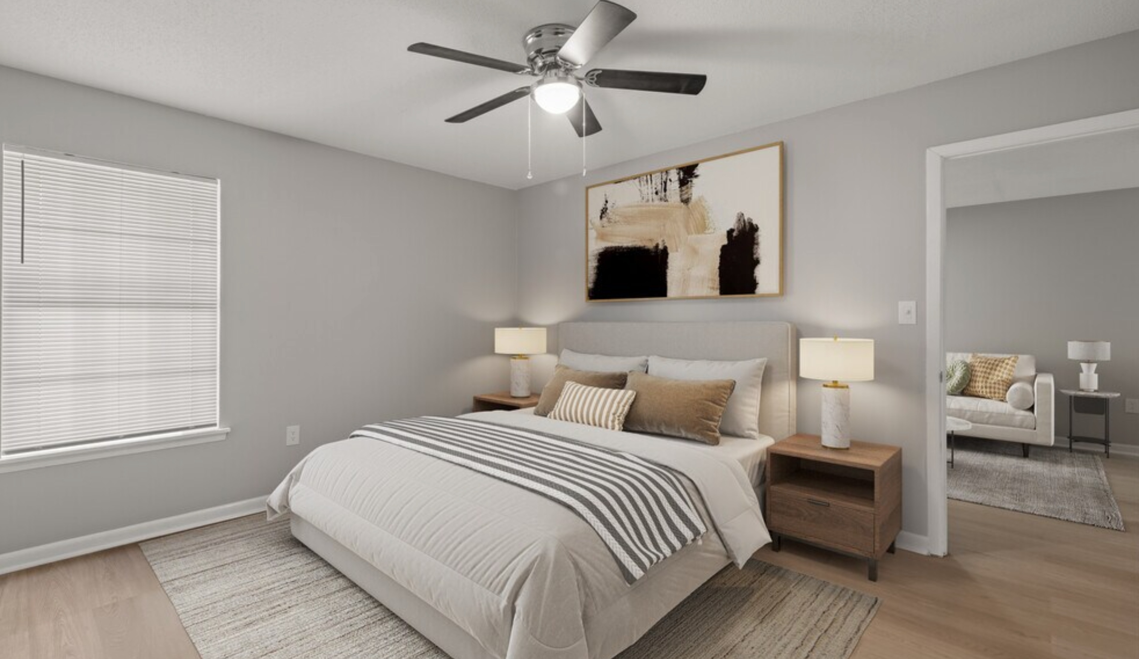 Modern bedroom with elegant decor, featuring a comfy bed, ambient lighting, and a sleek ceiling fan. Adjacent is a cozy living area with stylish furniture.