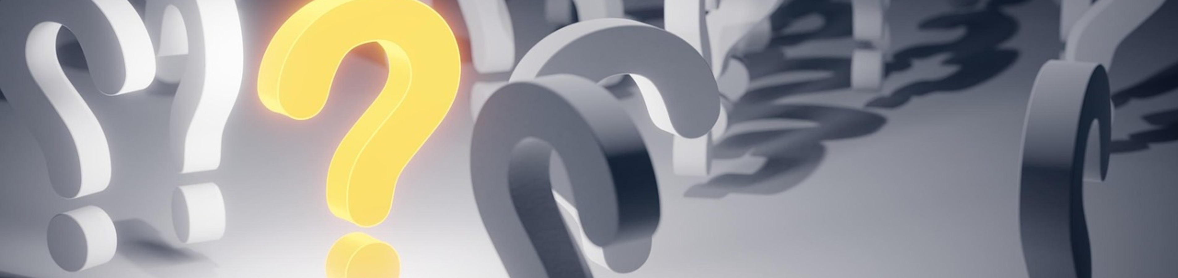 Artistic scene featuring a glowing yellow question mark amid gray question marks, symbolizing curiosity and inquiry.