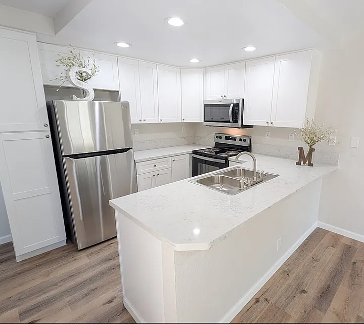 Kitchen with quartz counters and stainless steel appliances