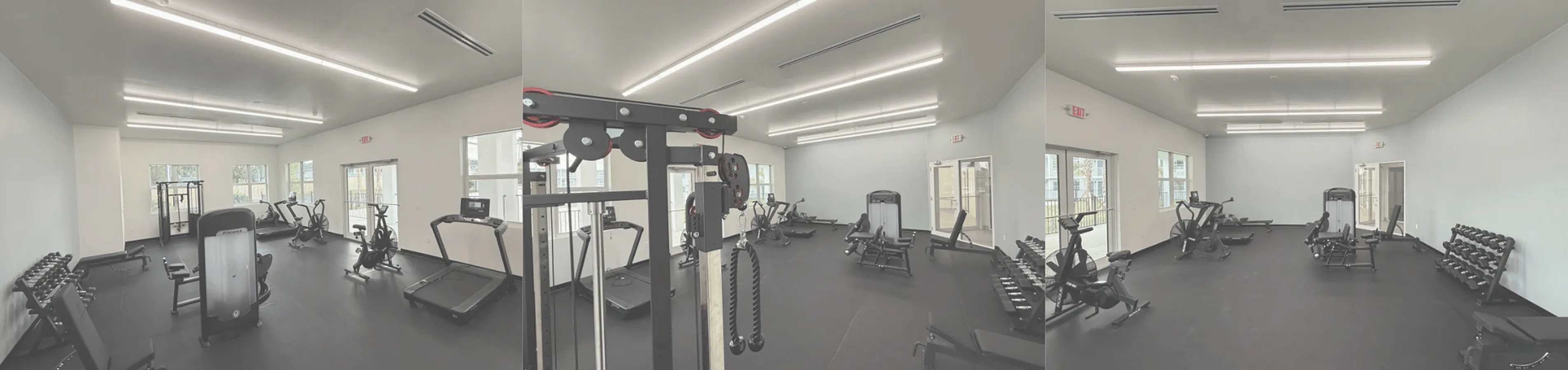 Modern fitness center featuring state-of-the-art equipment and bright, spacious design with ample natural light.