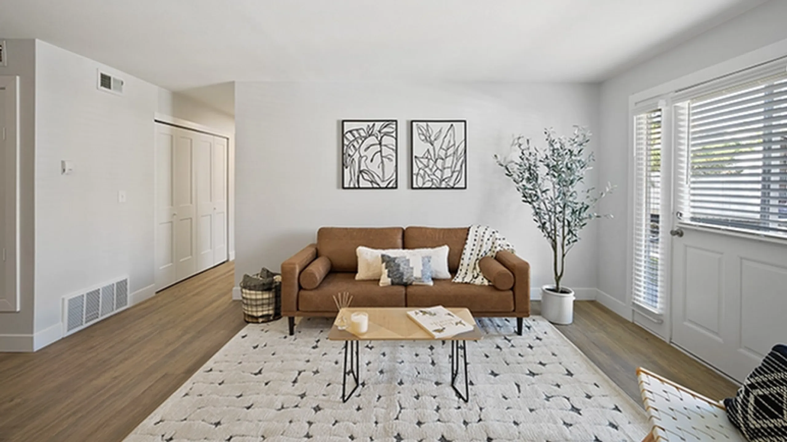 Chic modern living room with a stylish brown sofa, elegant wall art, and abundant natural light through large windows.