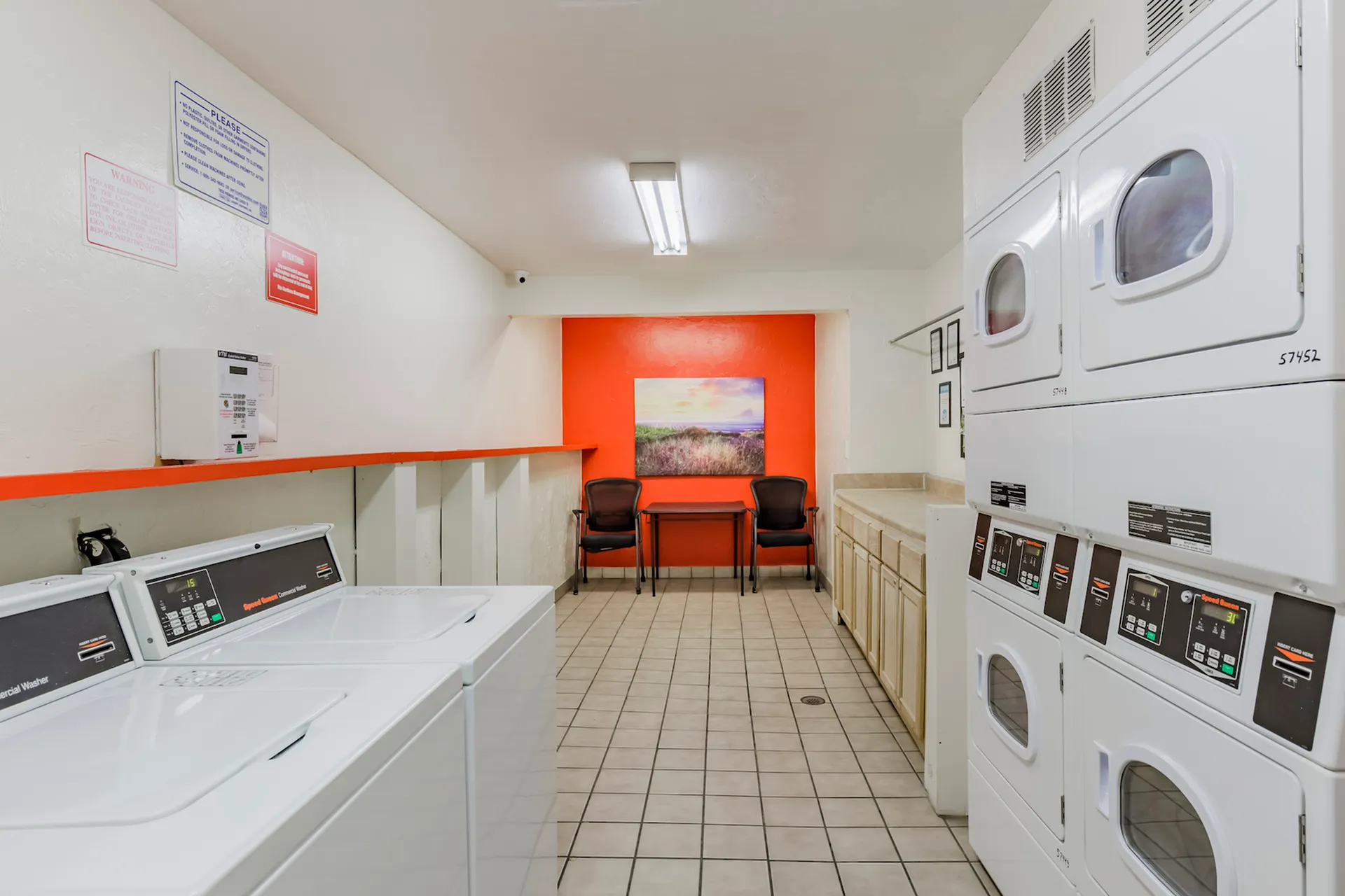 Community laundry facility with washers, dryers, and tiled floors