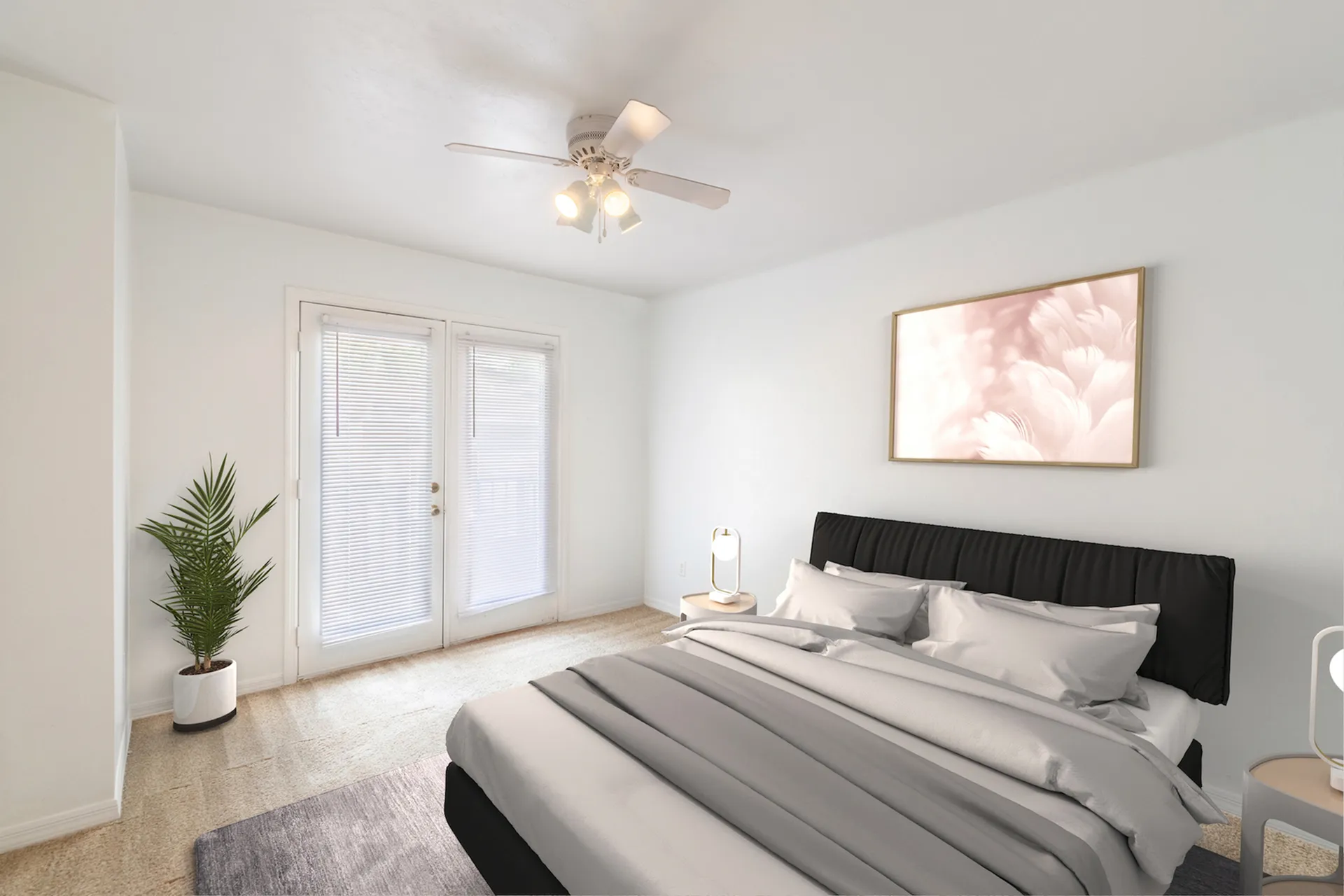 Carpeted bedroom with modern furniture including two end tables, two lamps, bed, potted plant, and two doors leading to an outdoor balcony.
