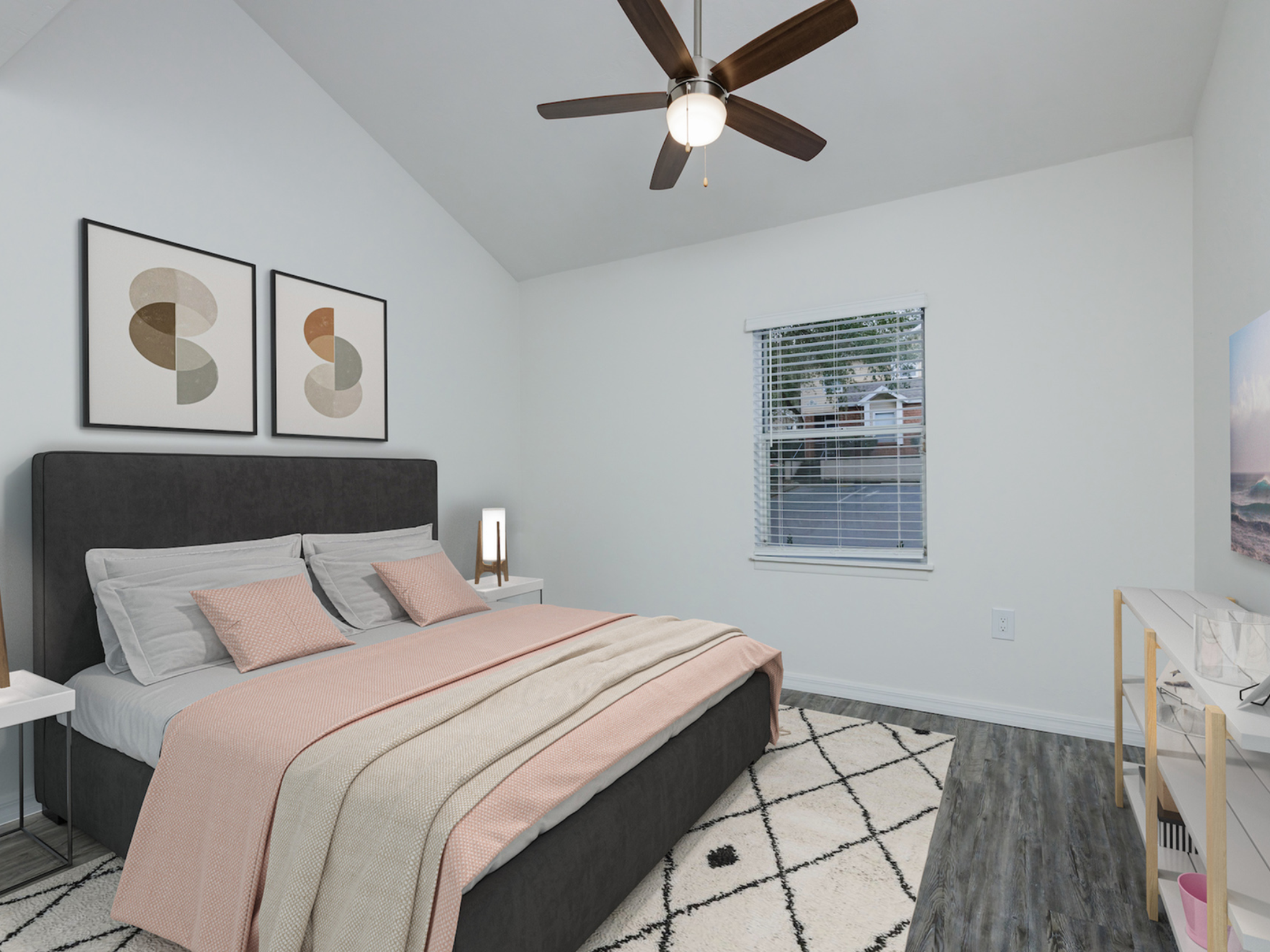 Downstairs bedroom with bed, window and ceiling fan.