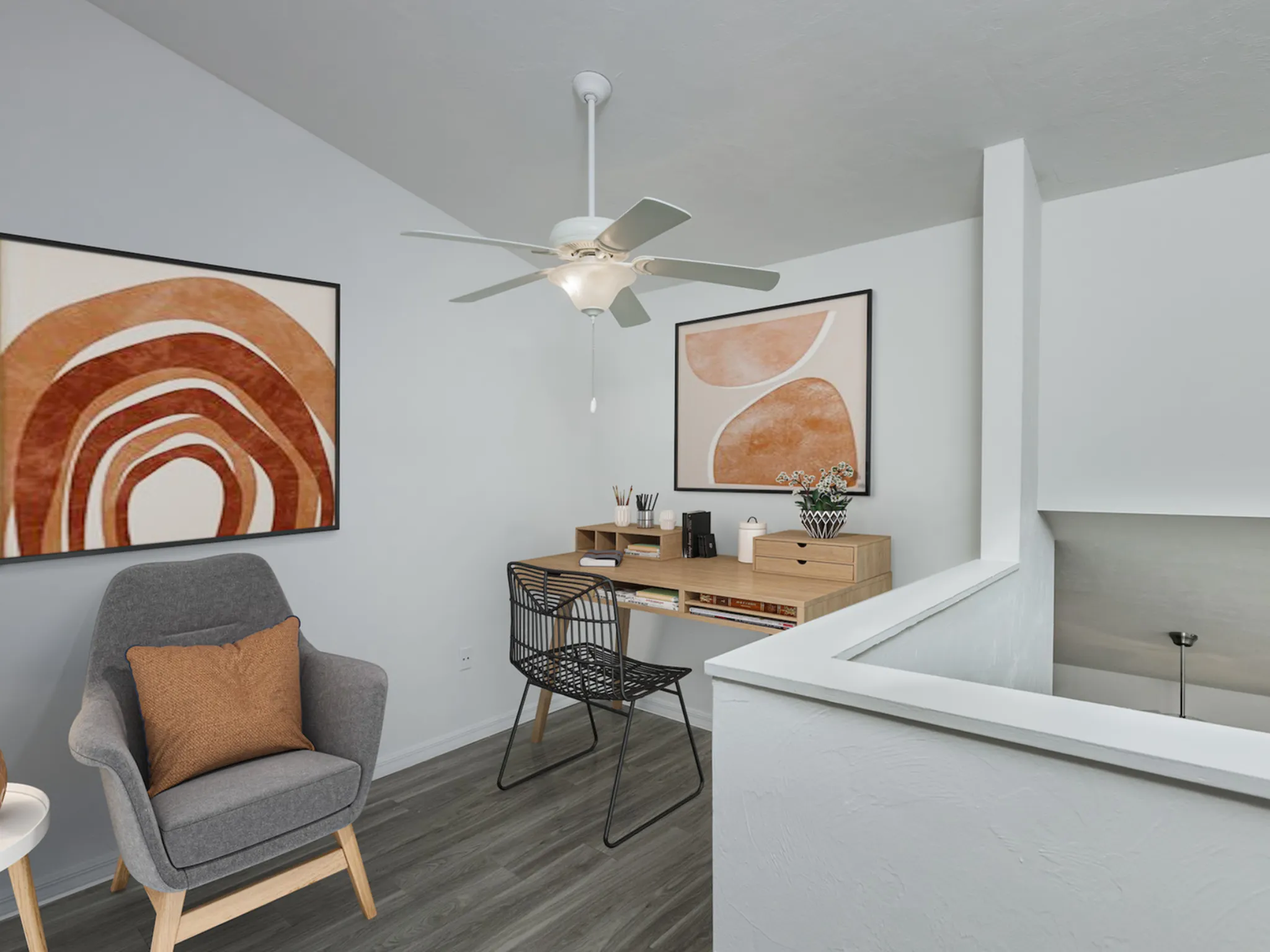 Loft in two bedroom with ceiling fan, chairs and desk.