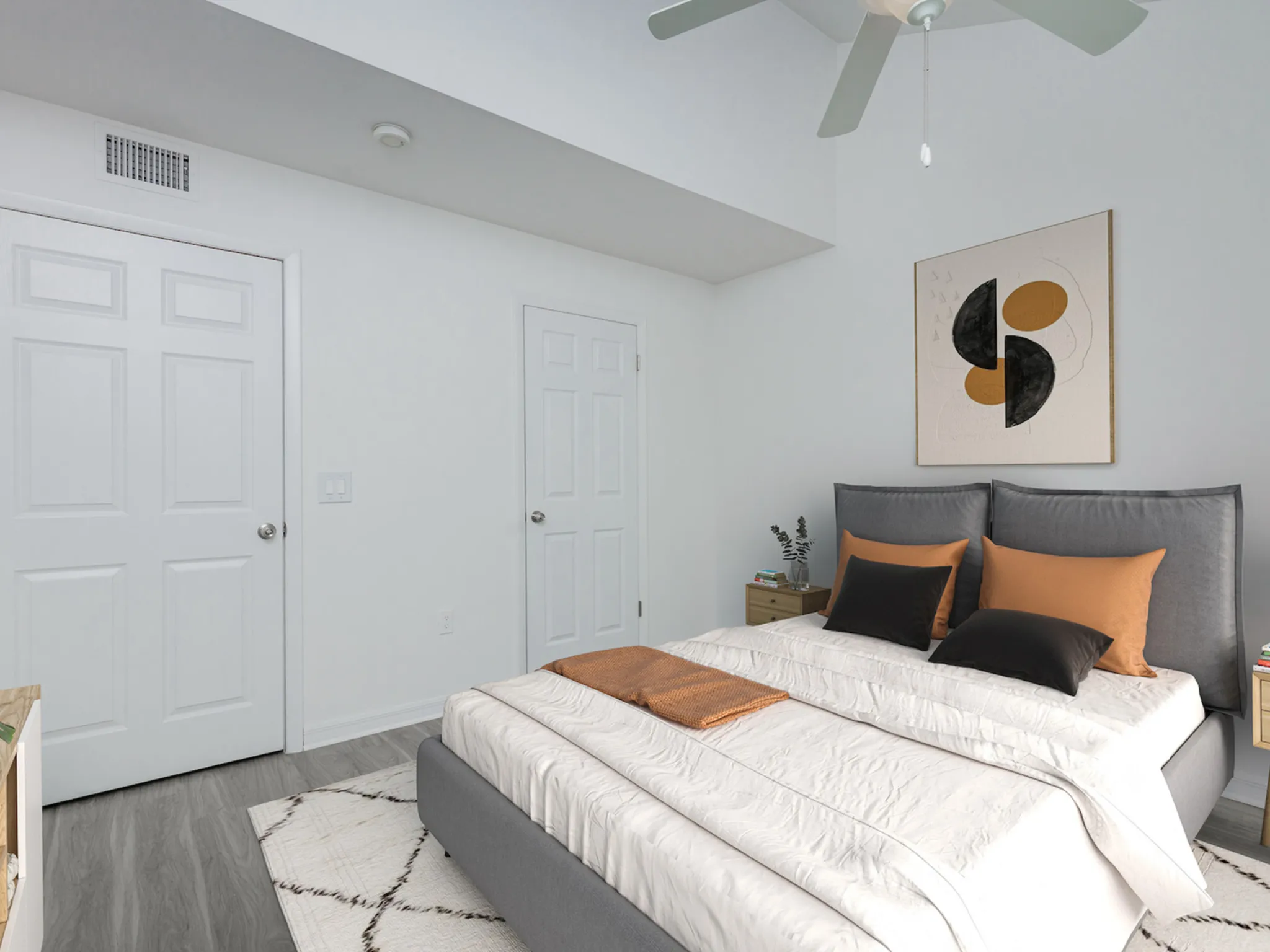 Downstairs bedroom with bed and ceiling fan.