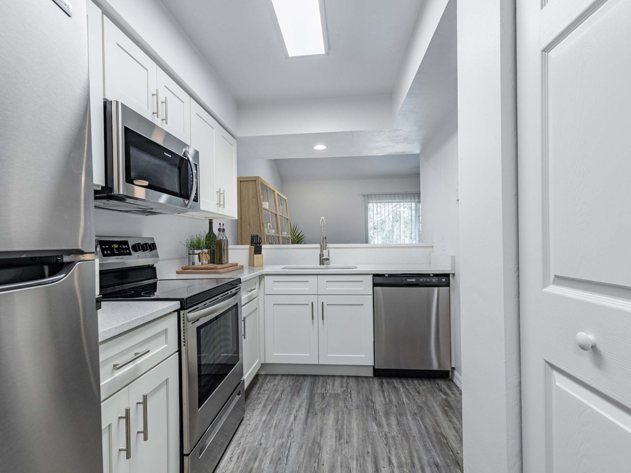 Kitchen with white shaker style cabinets and stainless steel appliances.