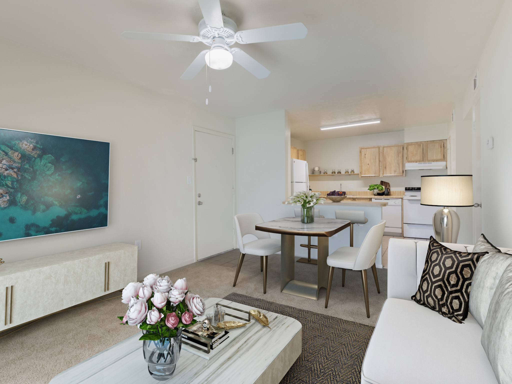 Living and dining area with couch, coffee table, dining table and chairs.