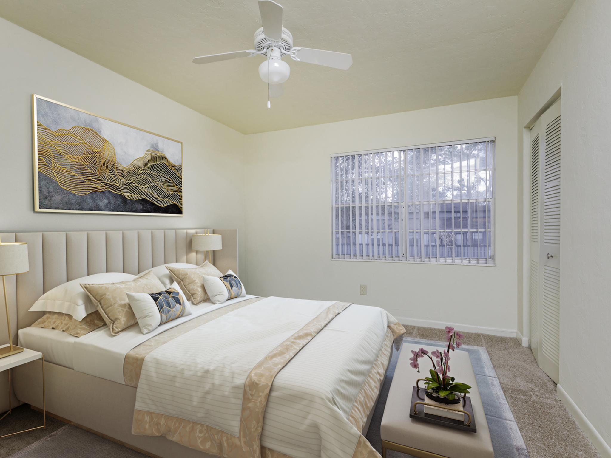 Bedroom with bed, window, ceiling fan and closet doors.