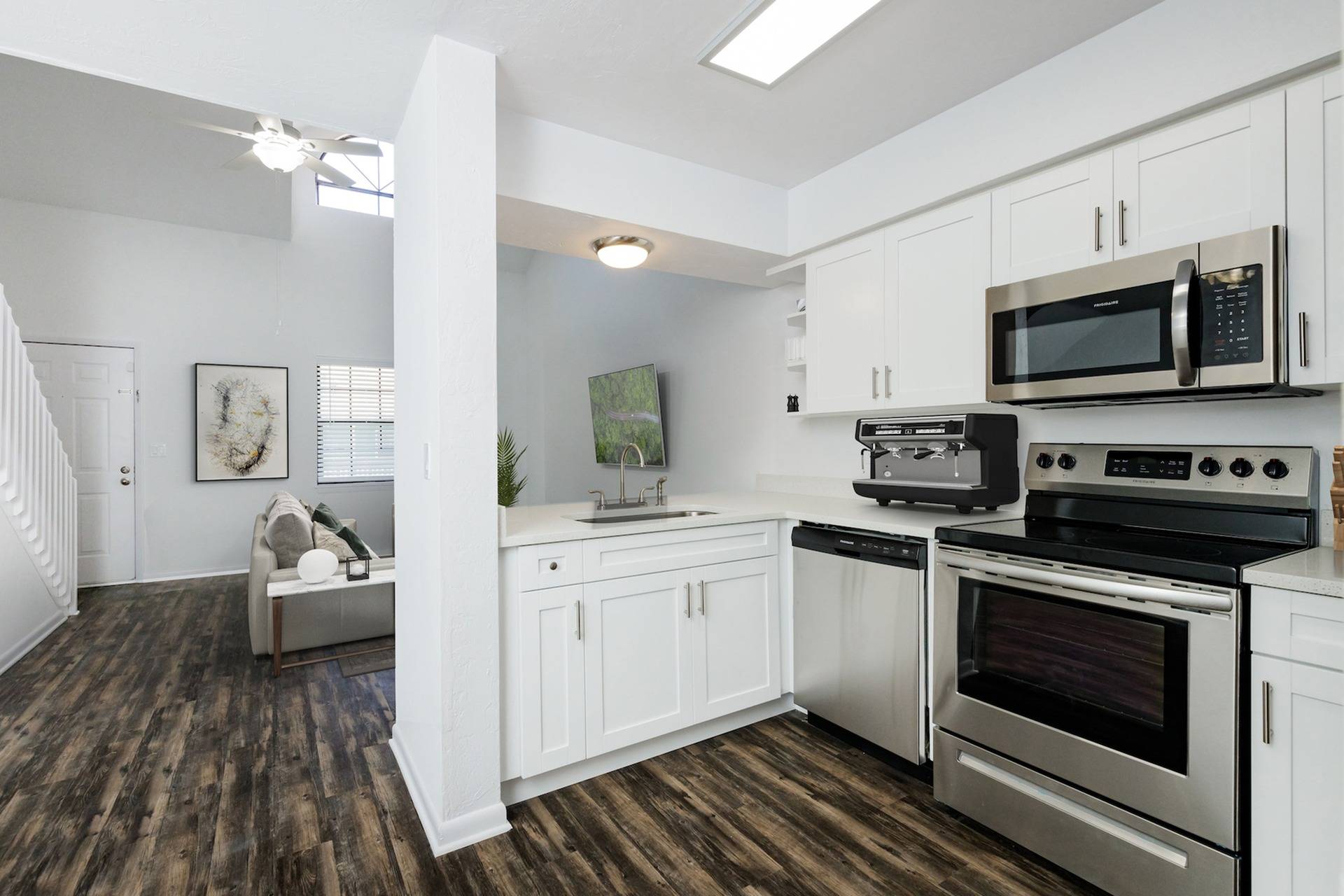Kitchen with stainless steel appliances, looking into living area..