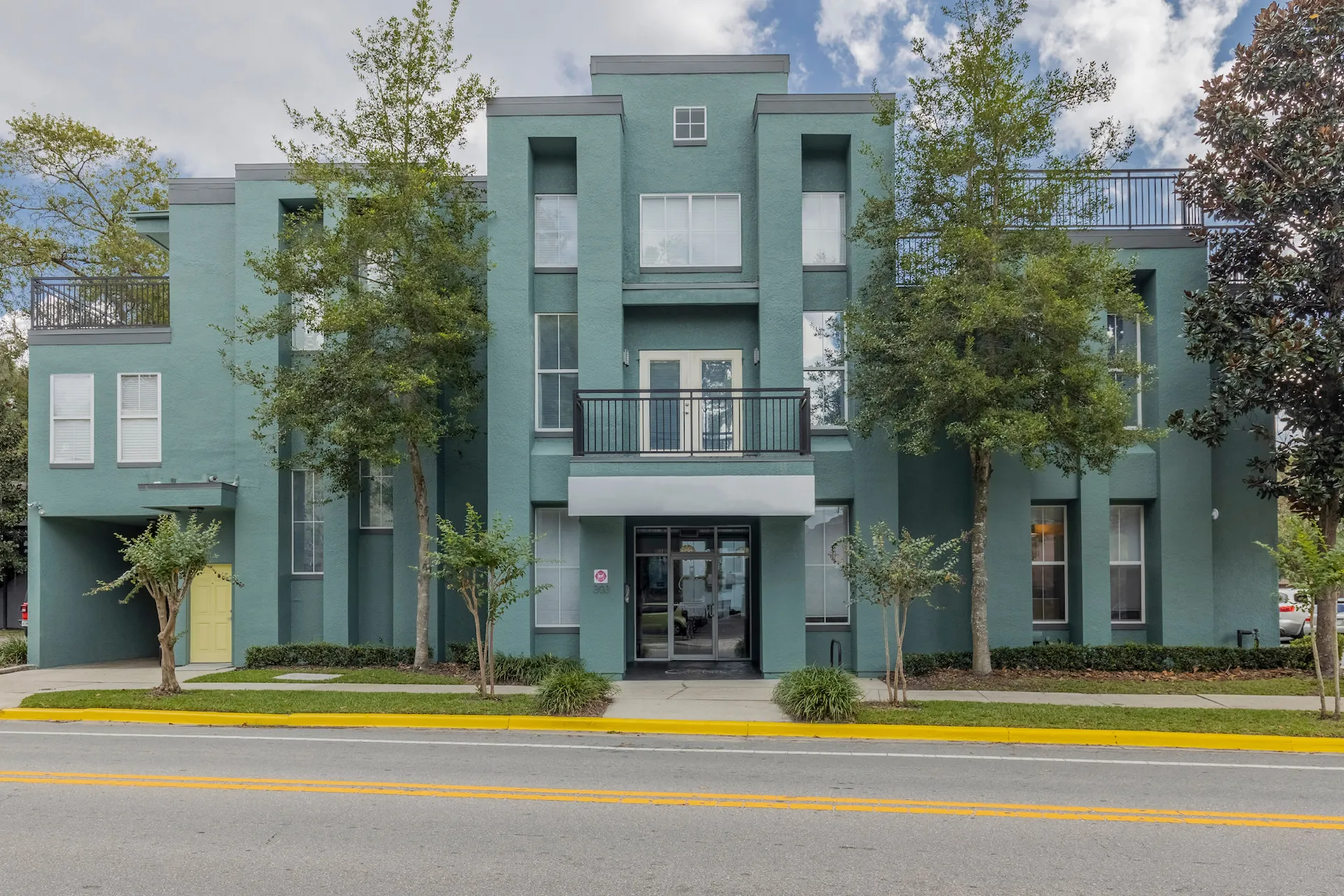 Facade of College Park and College Park at Midtown leasing office.  Trees in front of building.