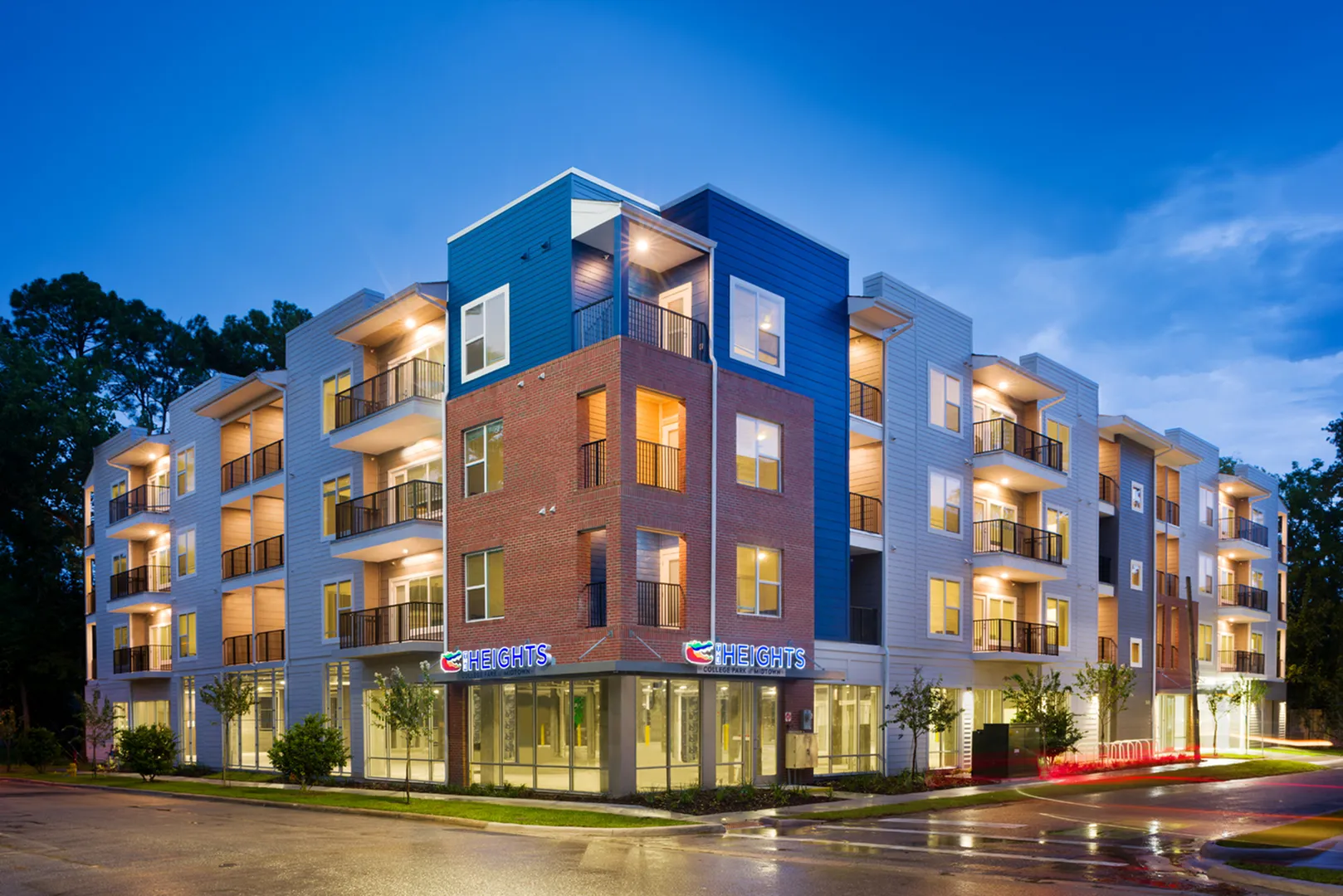 Beautiful, lighted, four floor building taken at dusk.