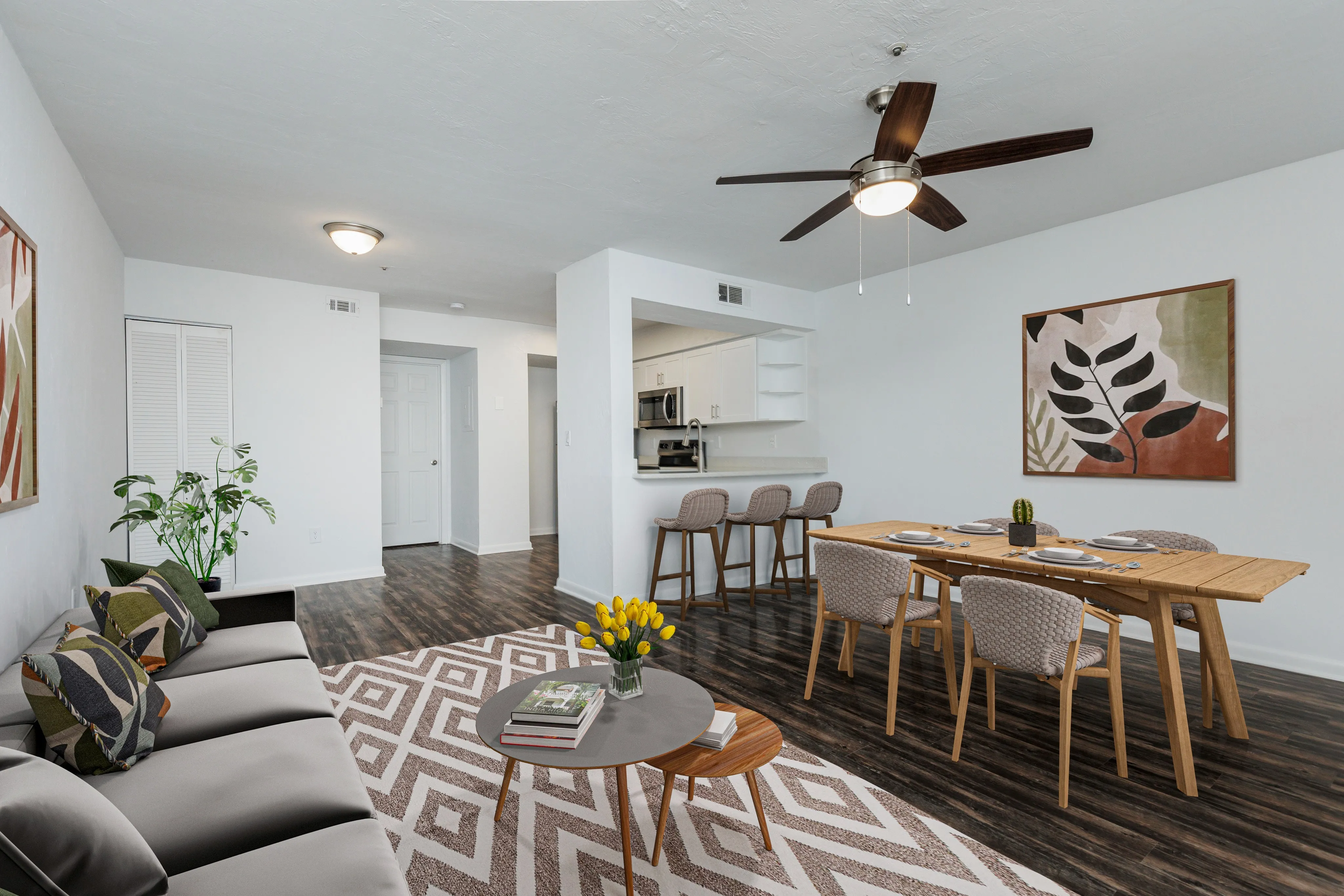 Living area looking into kitchen, breakfast bar with two stools