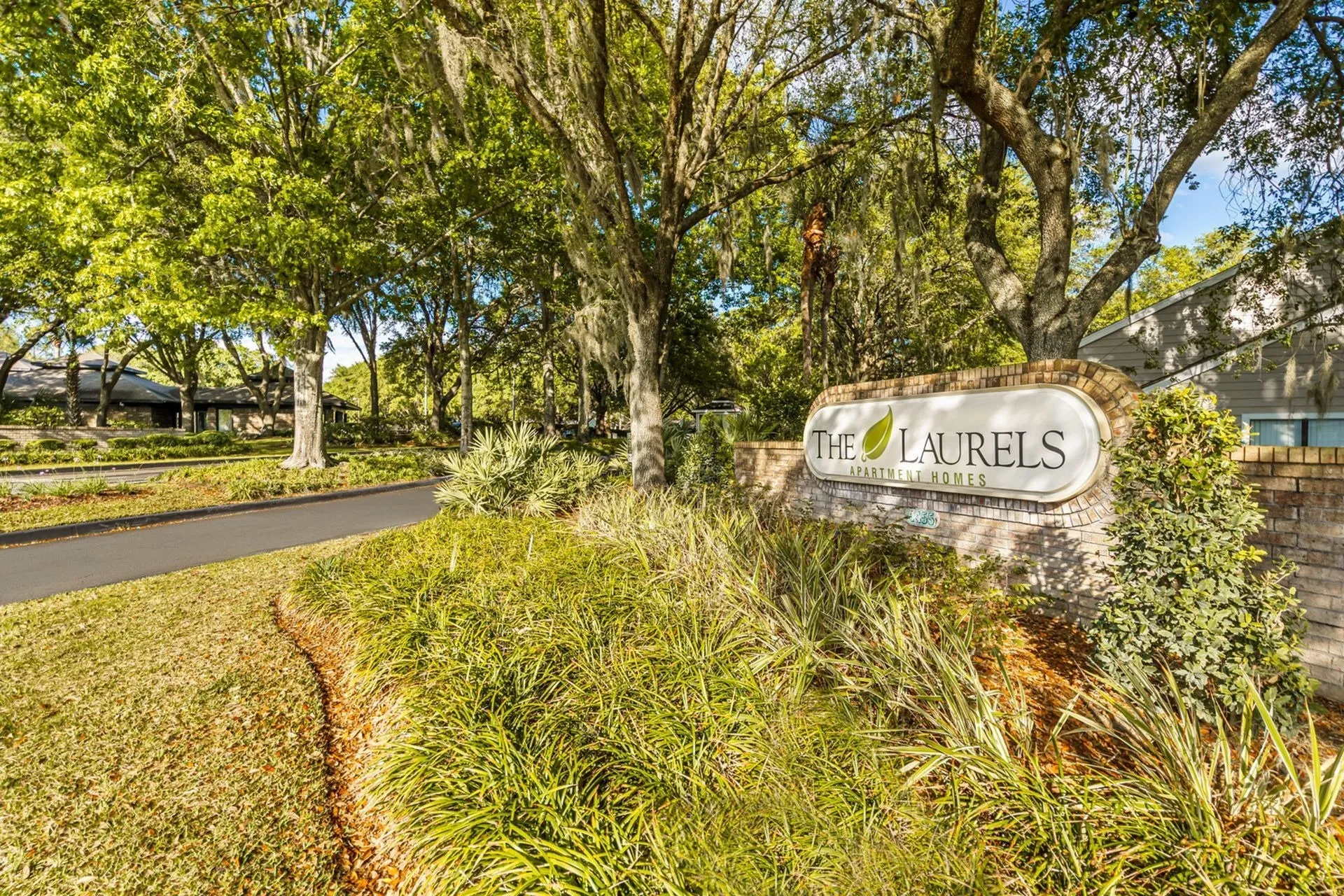 Community entrance with monument sign reading