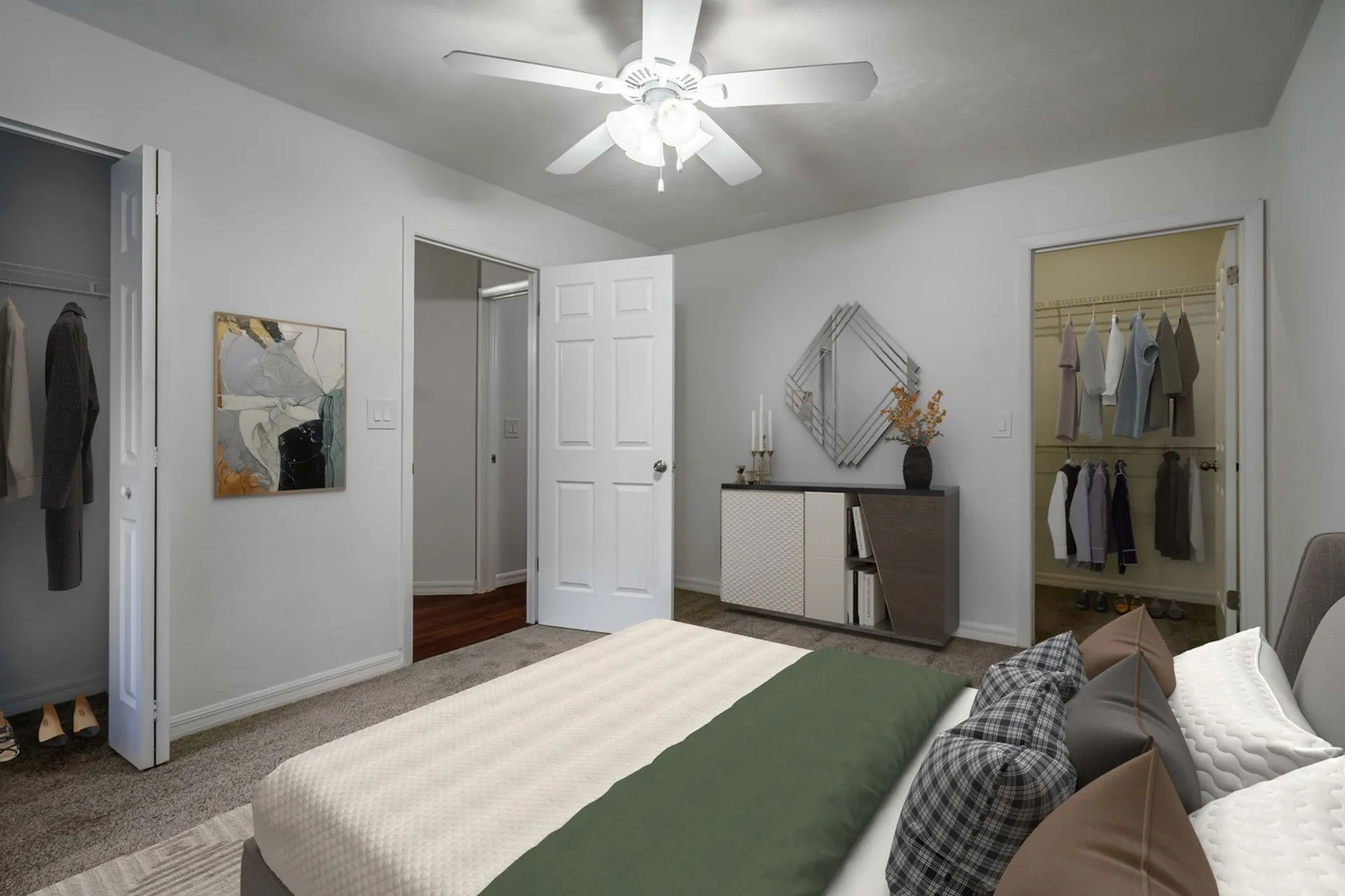 Bedroom with low queen bed and open closet. Clothes are hanging in the closet.